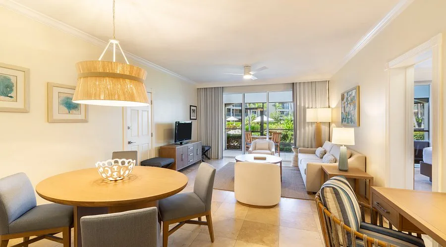 Two-bedroom oceanfront suite living and dining area at The Sands at Grace Bay.