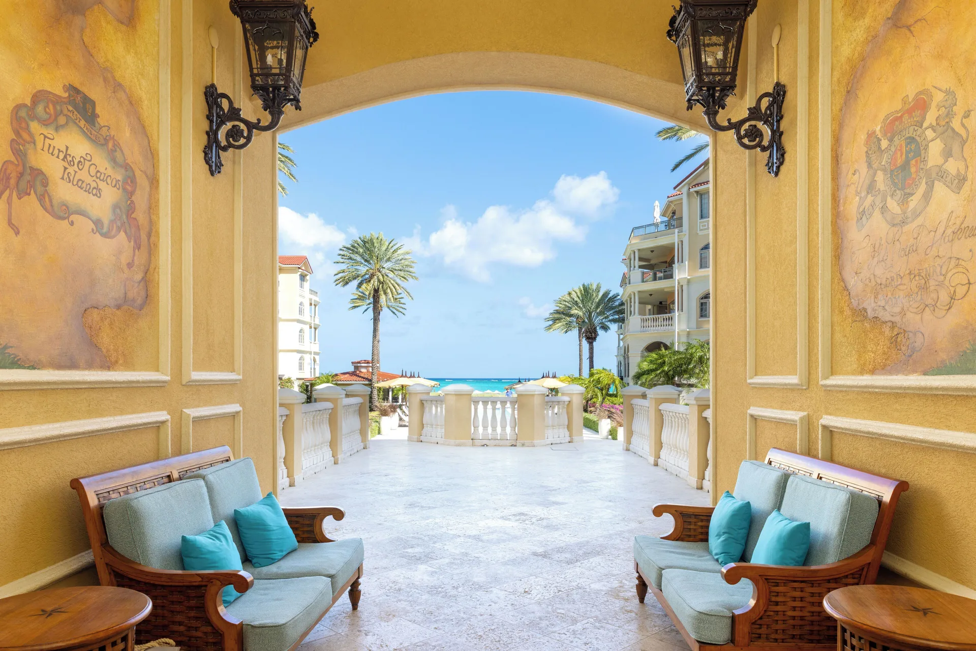Arched resort passage with benches and ocean view at The Somerset on Grace Bay.