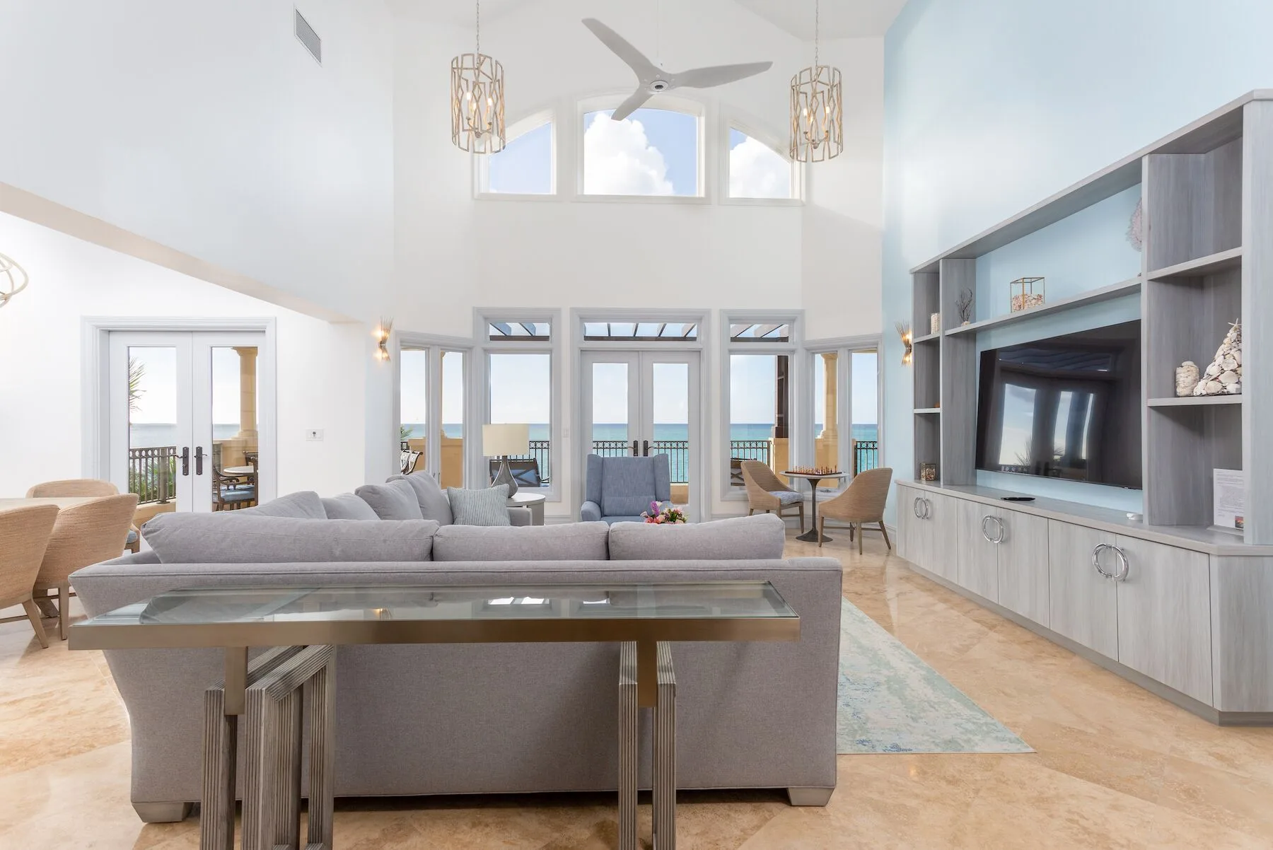 High-ceiling living room with ocean-facing doors at The Somerset on Grace Bay.