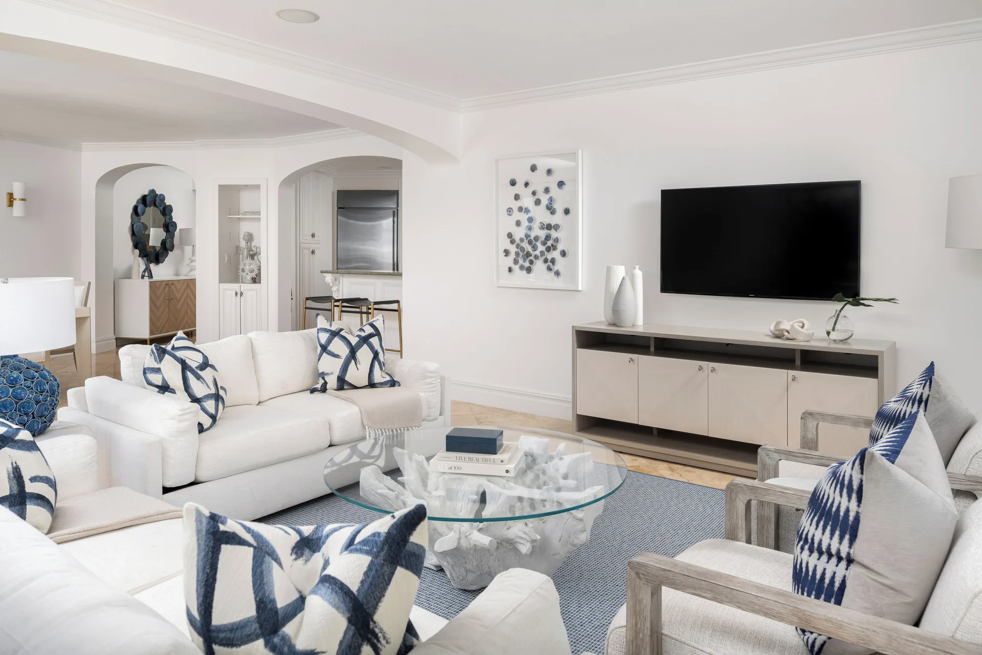 Bright living room with white sofas and blue accents at The Somerset on Grace Bay.