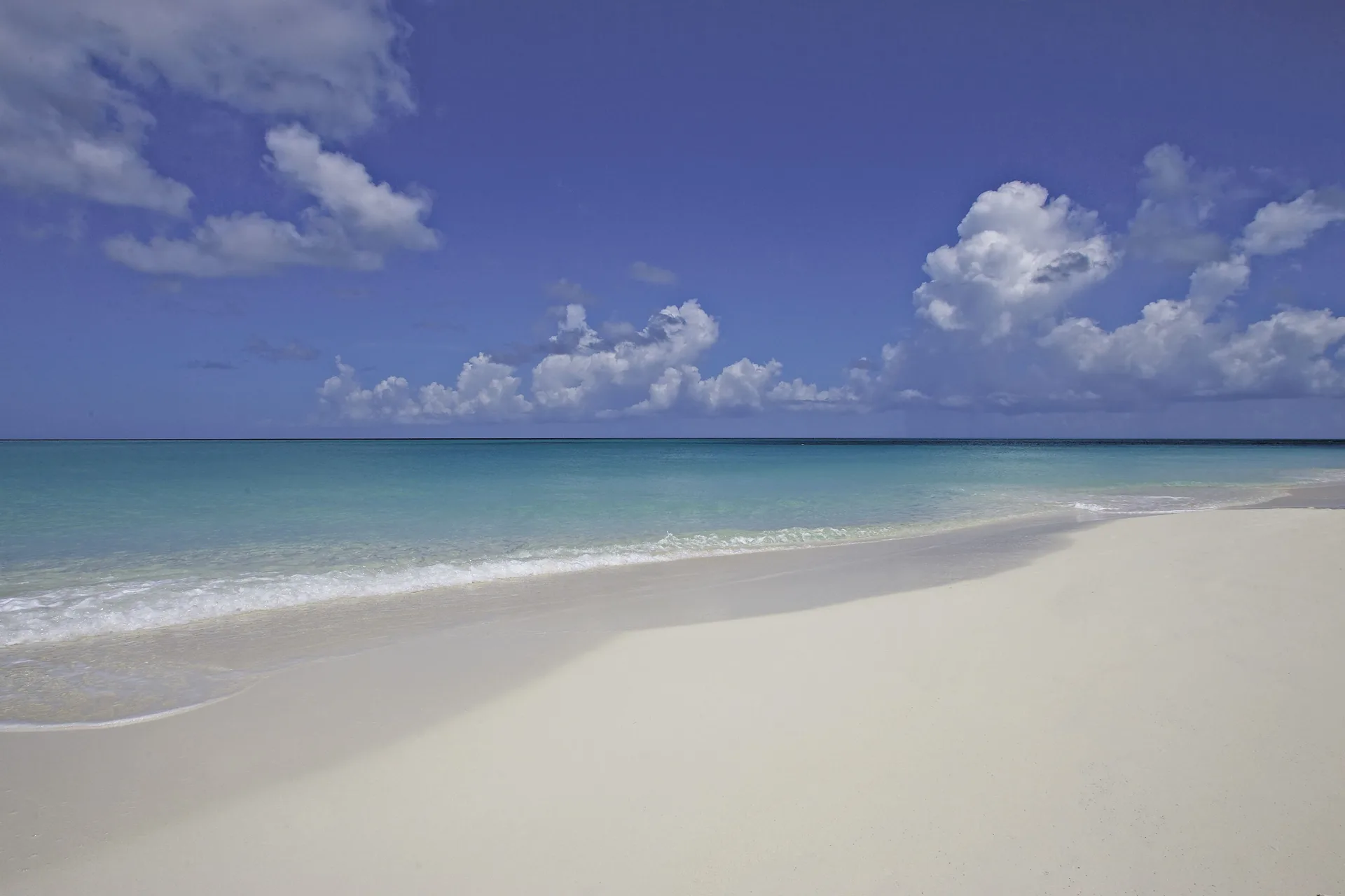 Empty white sand shoreline and calm turquoise sea at The Somerset on Grace Bay.