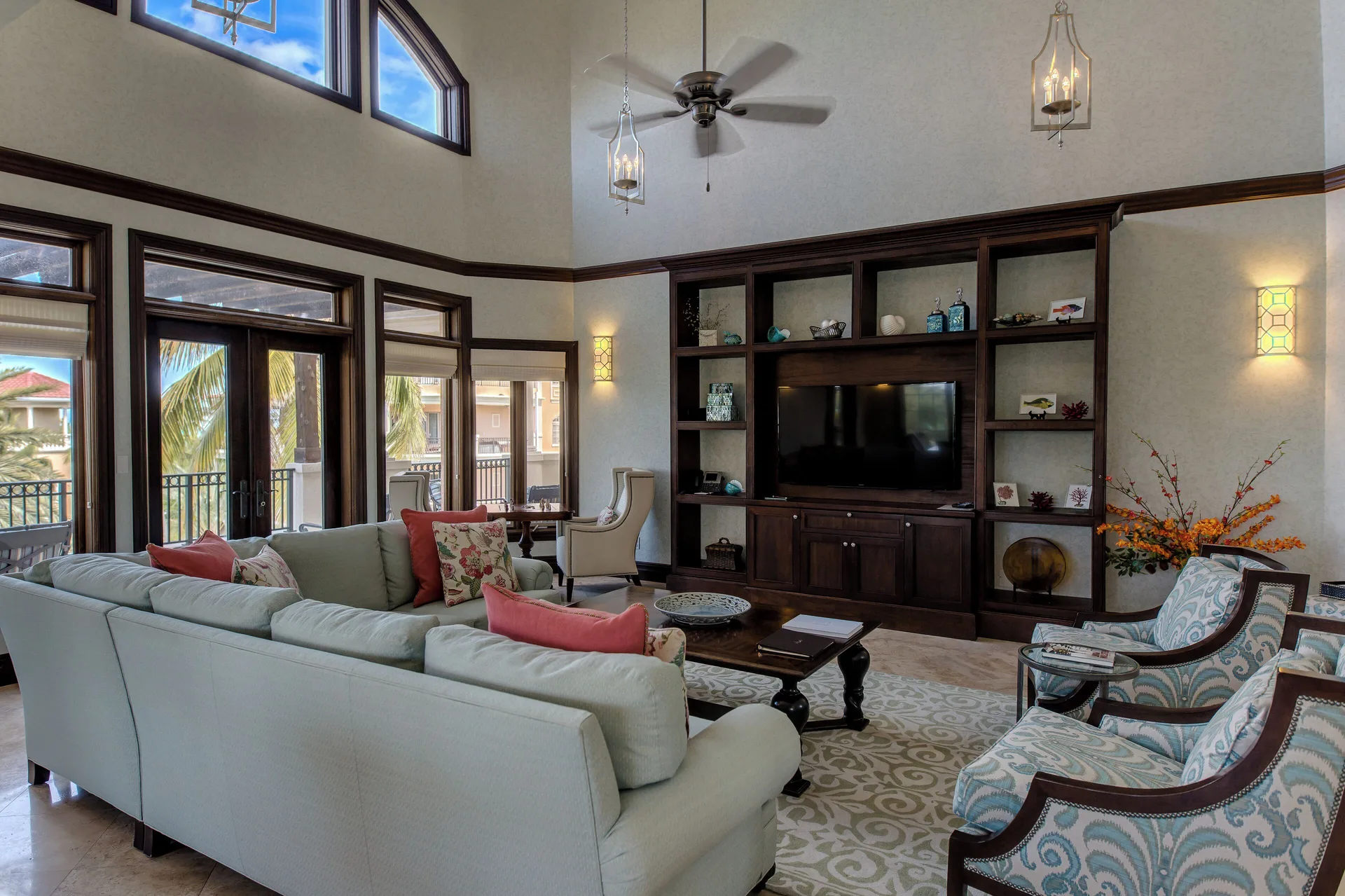 Traditional living room with balcony doors and built-in shelves at The Somerset on Grace Bay.