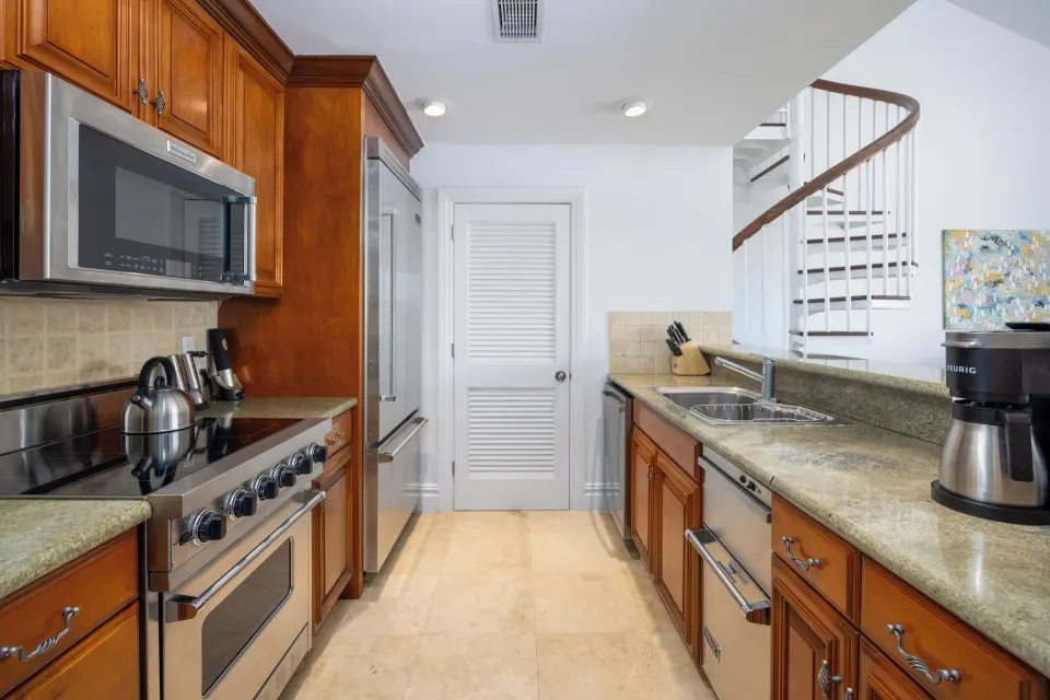 1 Bedroom Residence kitchen with wood cabinetry at The Somerset on Grace Bay.