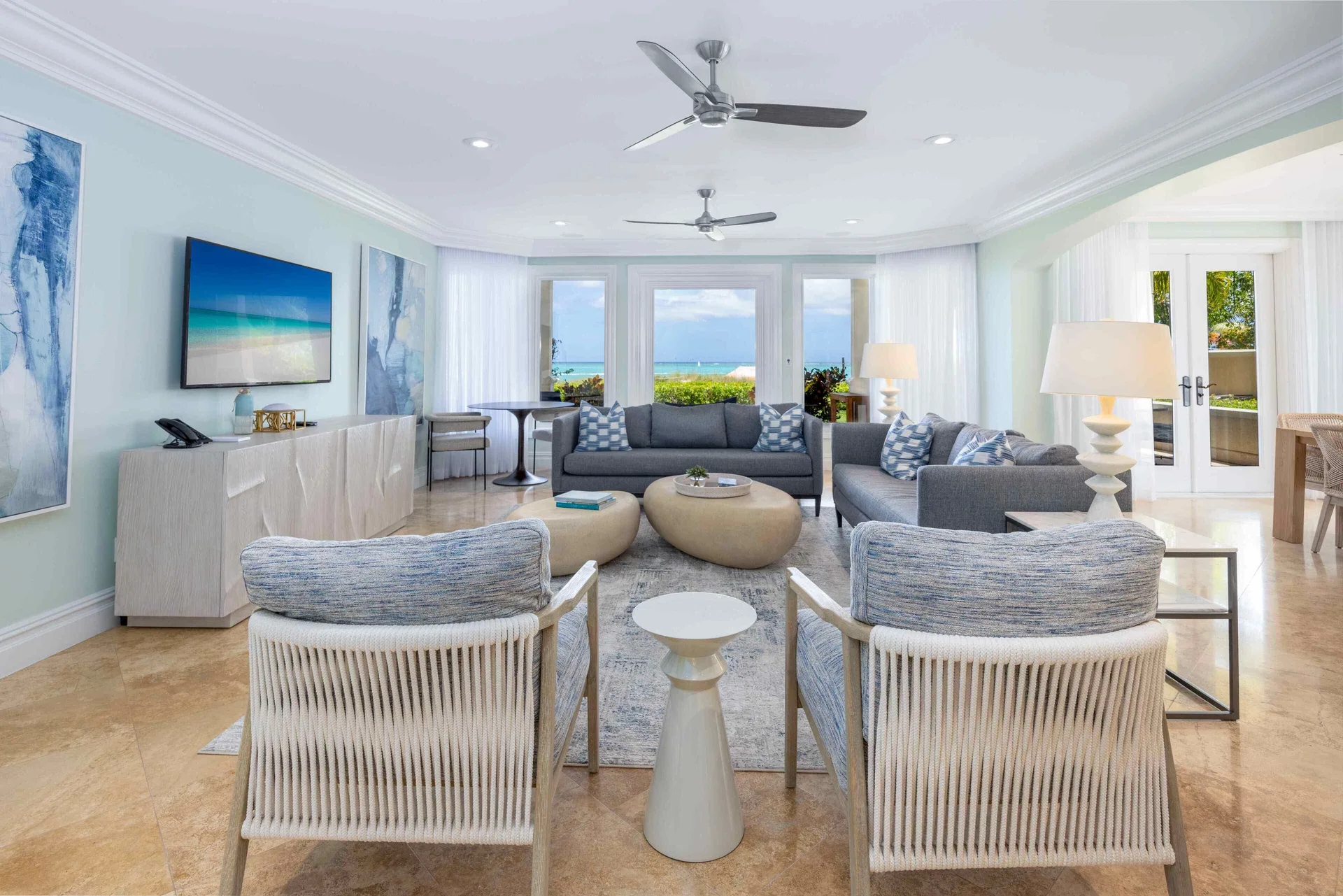 Oceanfront living room with sofas and sea views at The Somerset on Grace Bay.