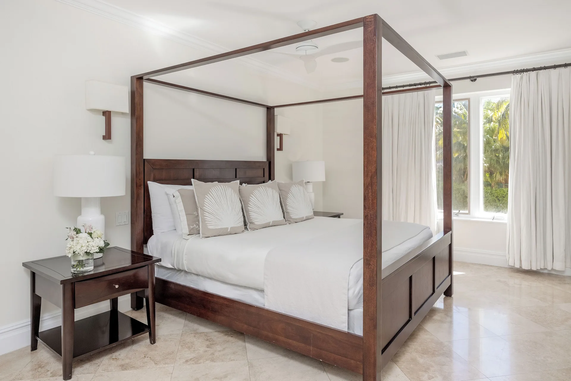 King bedroom in the Family Villa at The Somerset on Grace Bay with four-poster bed and garden-facing windows.