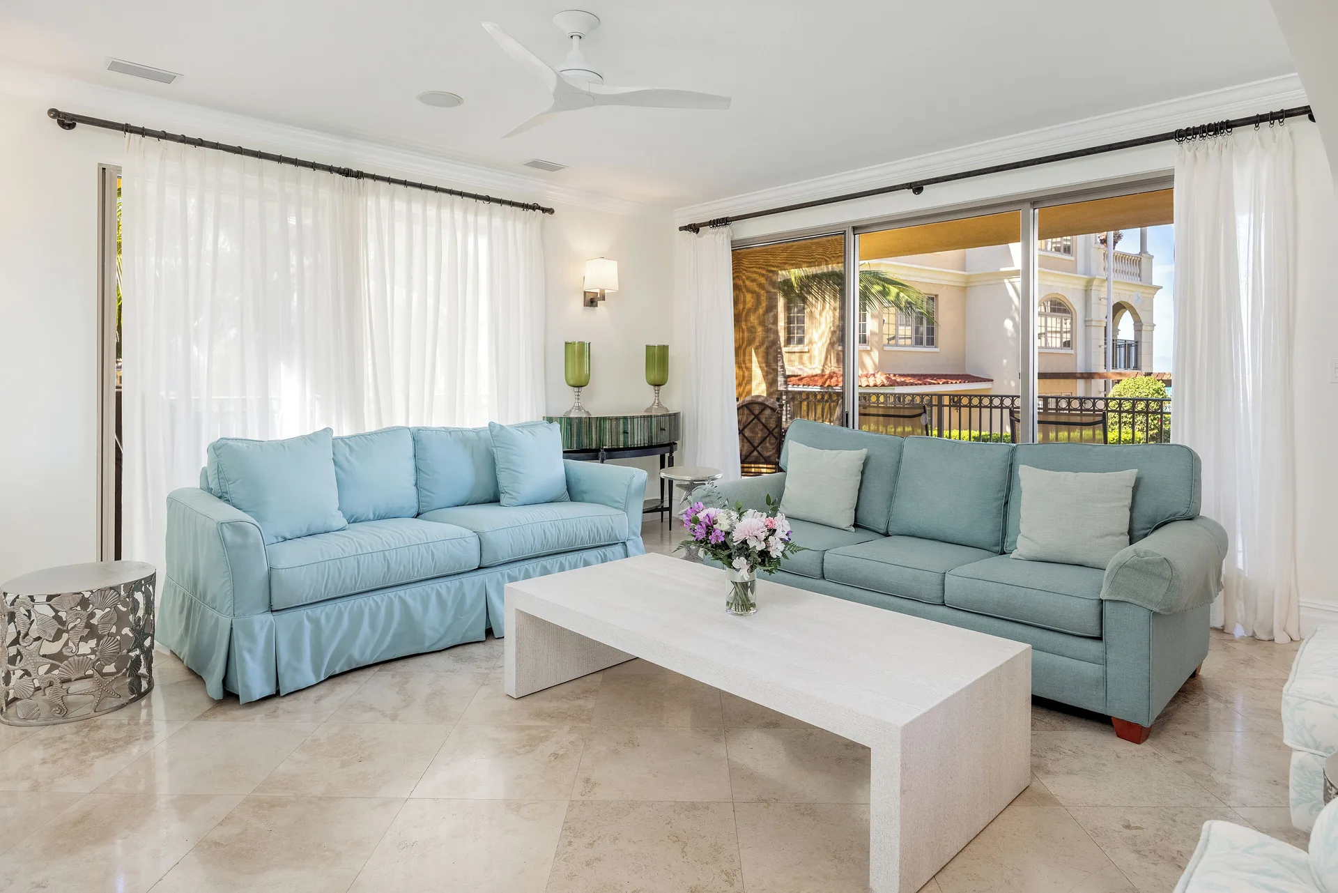 Family Villa 3 Bedrooms Pool View living room with blue sofas at The Somerset on Grace Bay.