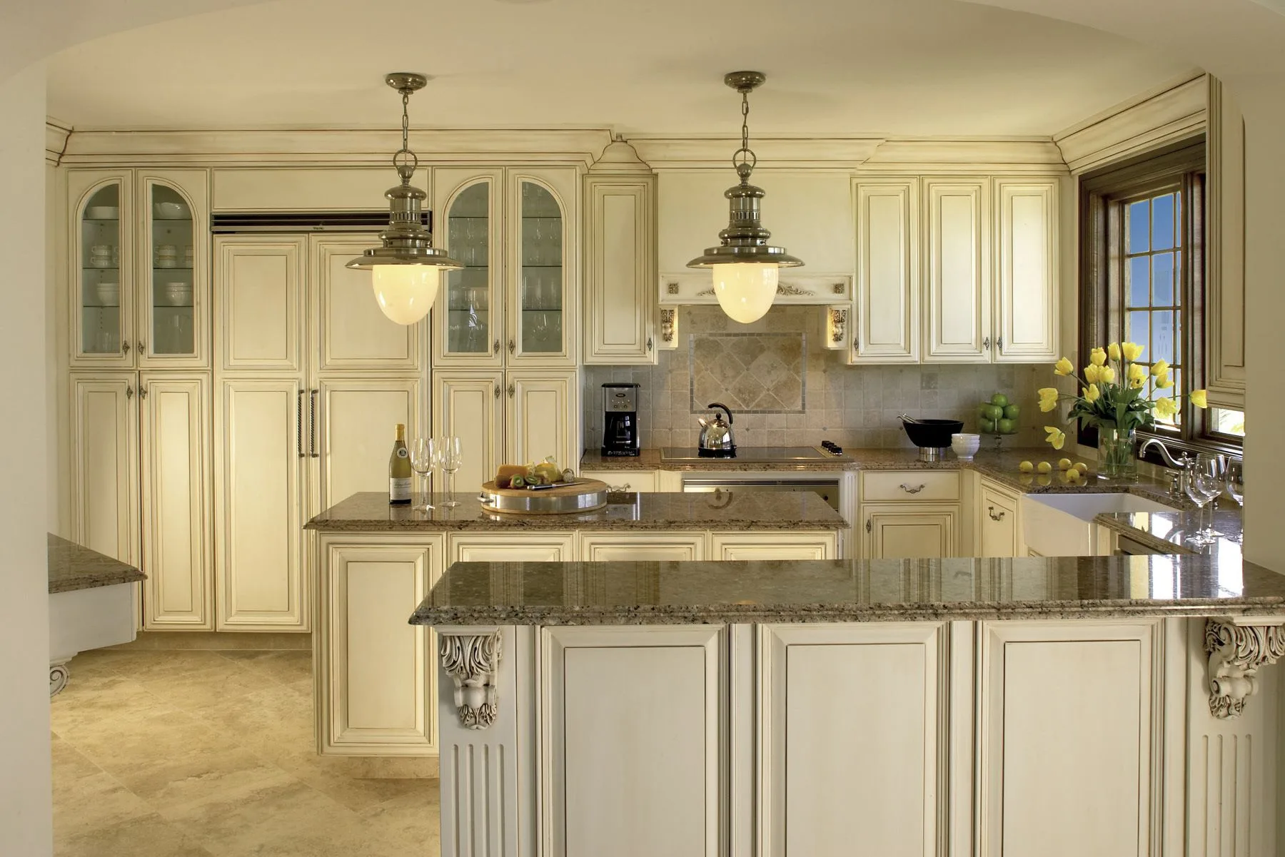 Penthouse kitchen with cream cabinetry and stone counters at The Somerset on Grace Bay.