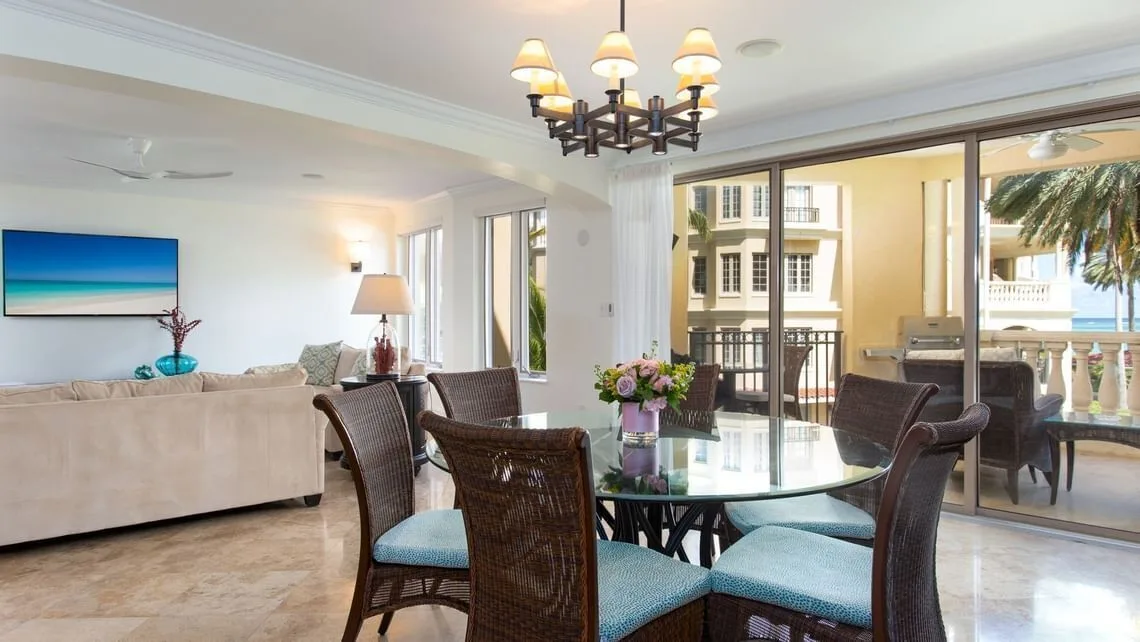 Villa ocean view dining area beside balcony doors at The Somerset on Grace Bay.