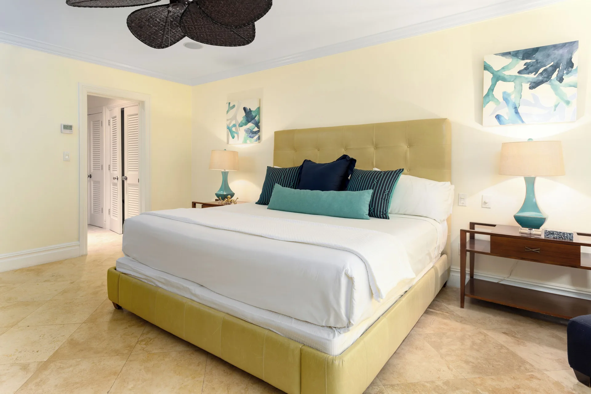 Villa ocean view bedroom with a king bed and turquoise accents at The Somerset on Grace Bay.
