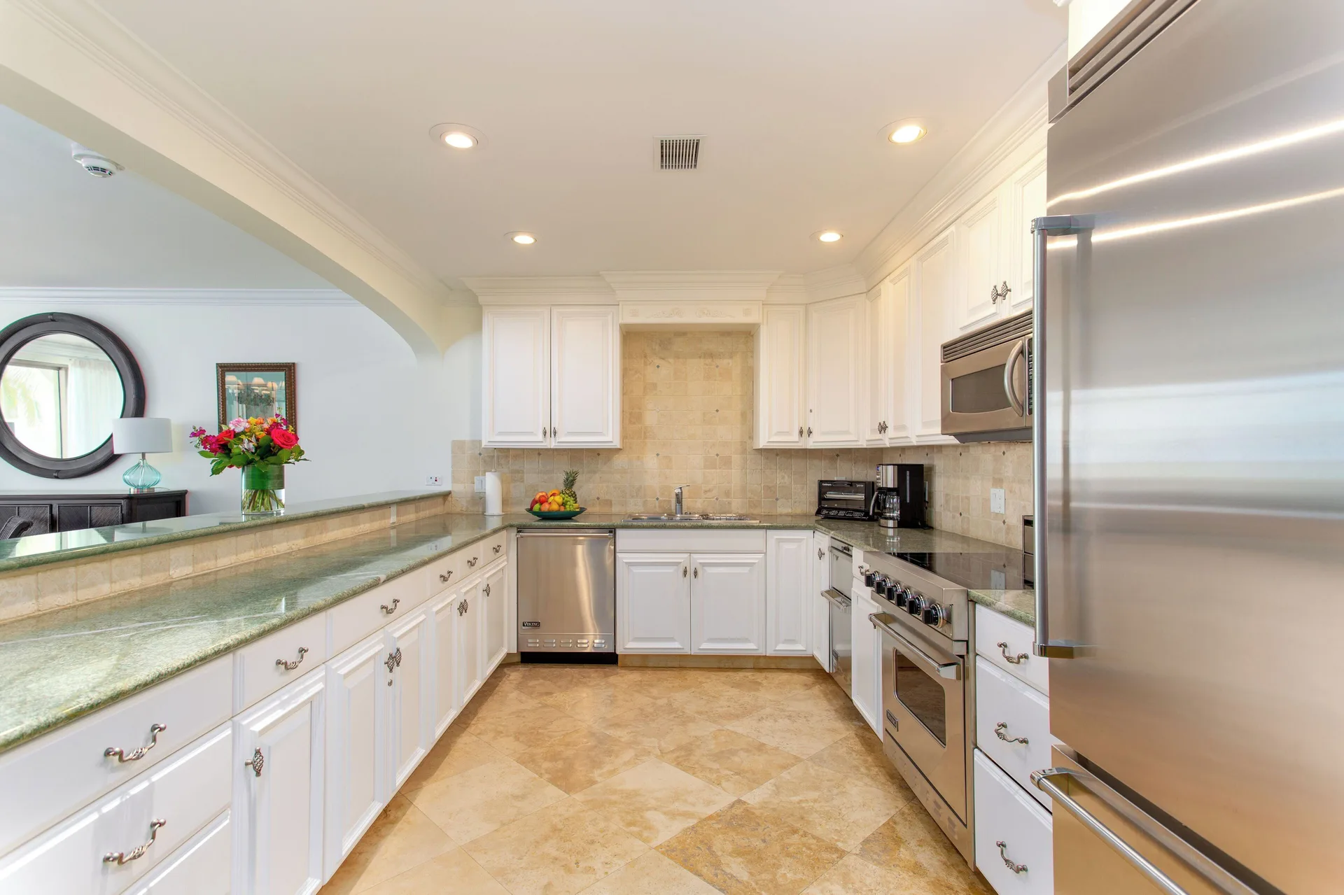 Villa ocean view kitchen with white cabinetry and stainless appliances at The Somerset on Grace Bay.