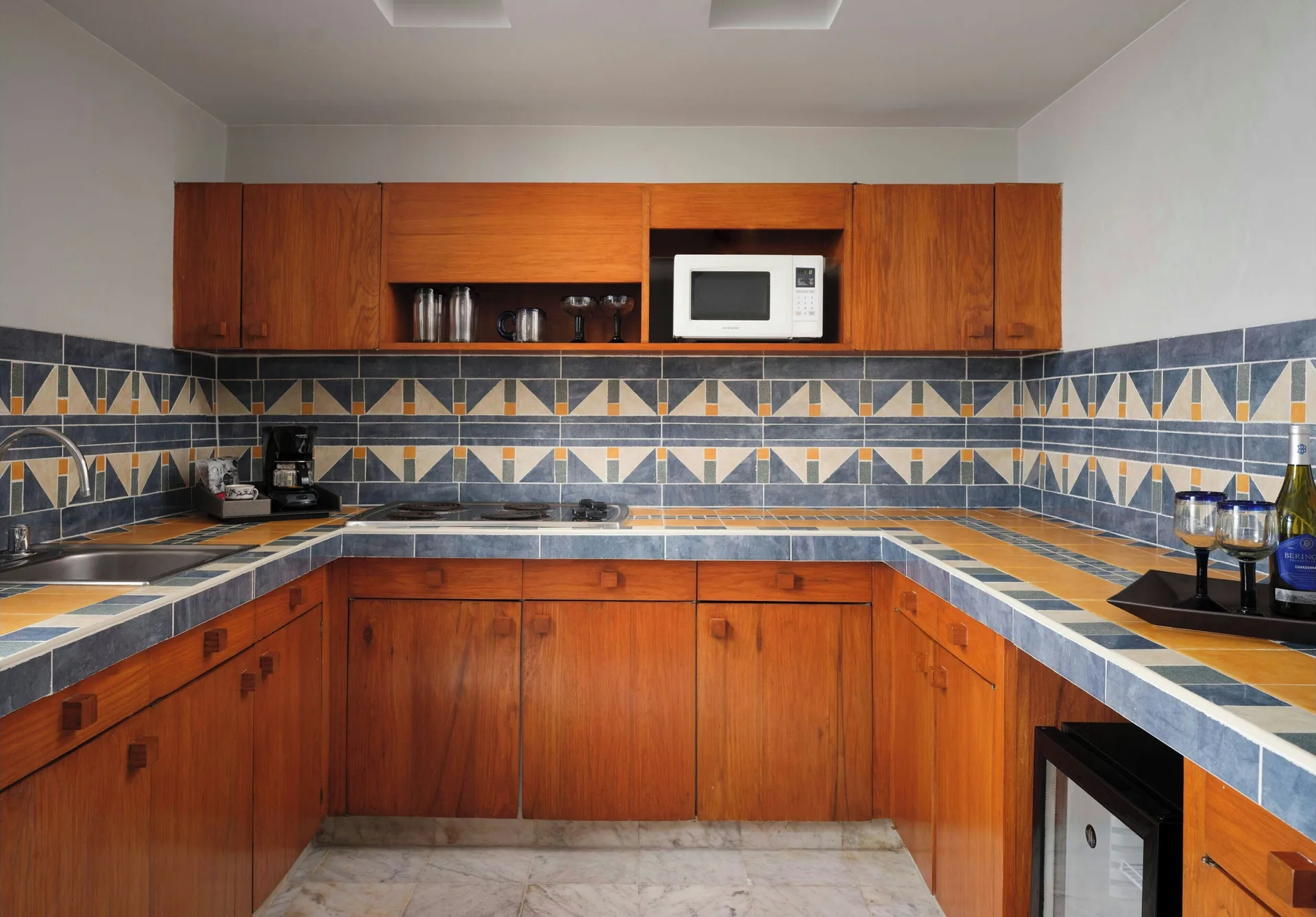 Presidential Suite kitchen with wood cabinetry and tiled counters at The Westin Resort & Spa, Cancun.