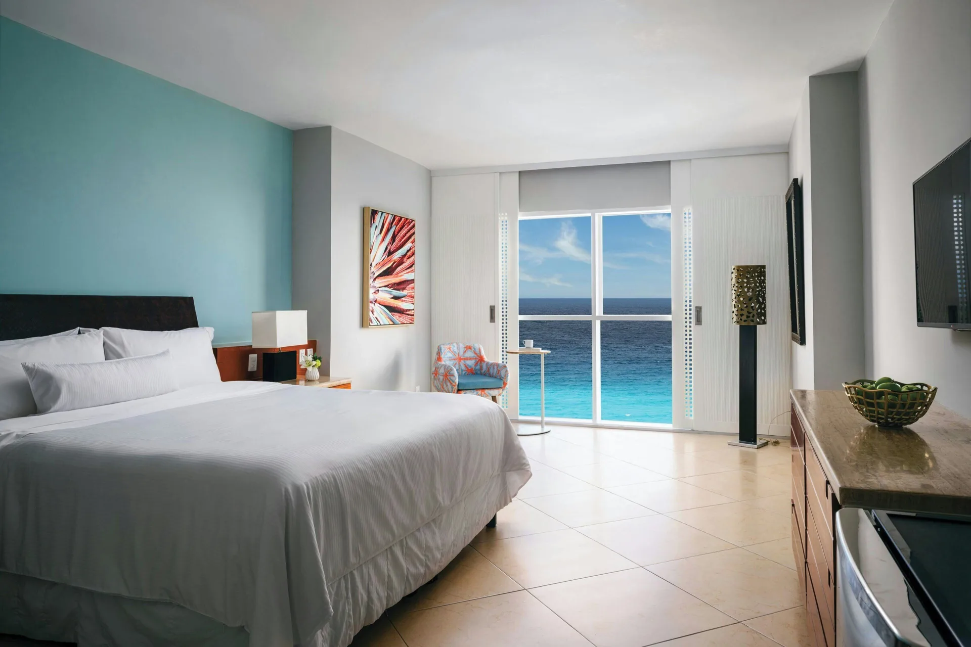 Ocean View king room at The Westin Resort & Spa, Cancun with a bed, TV, dresser, and sea-facing windows.