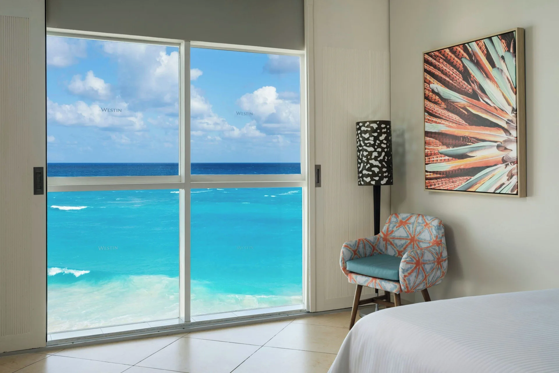 Ocean View room seating by large windows at The Westin Resort & Spa, Cancun overlooks the Caribbean.