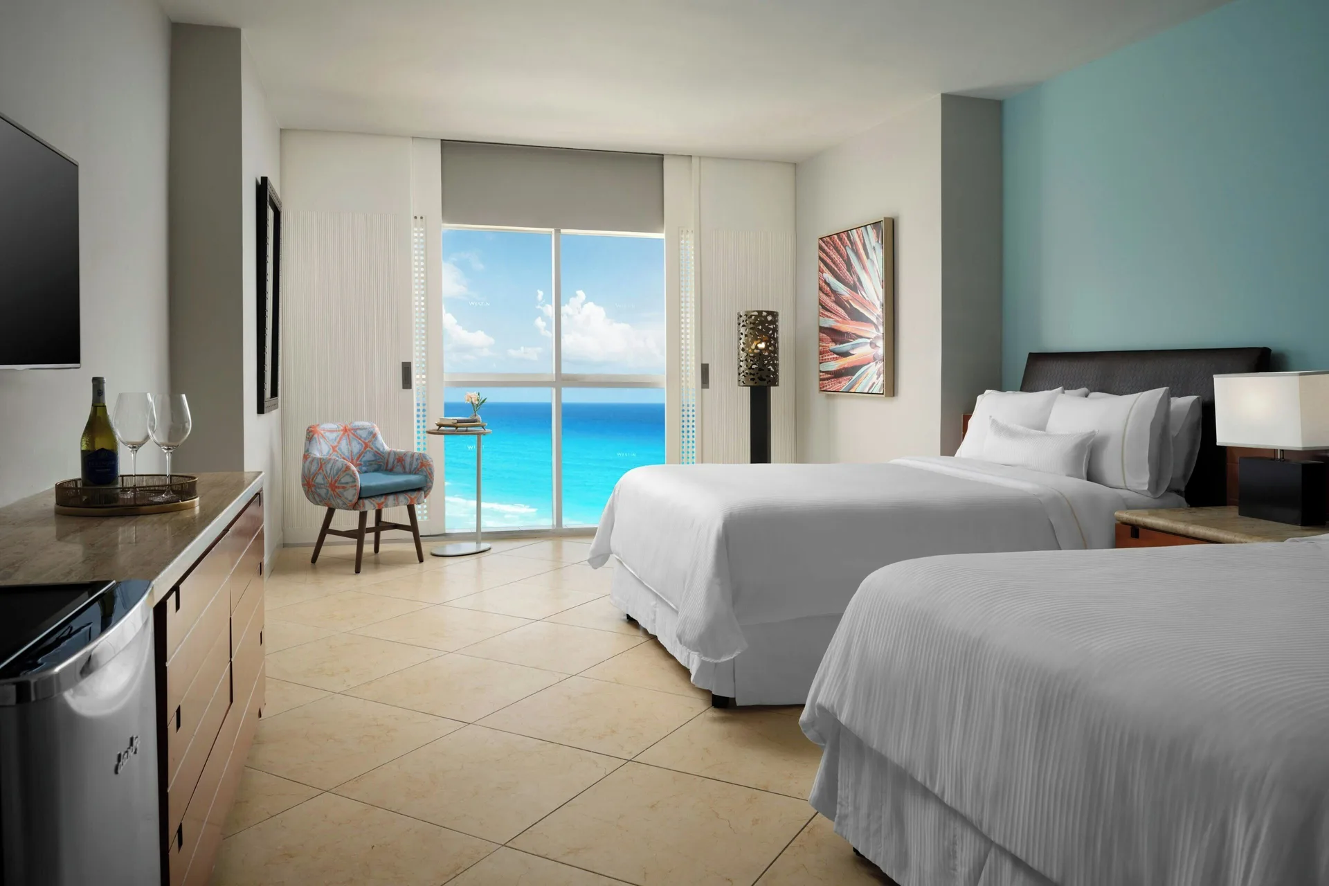 Ocean View double room at The Westin Resort & Spa, Cancun with two beds, dresser, TV, and ocean windows.