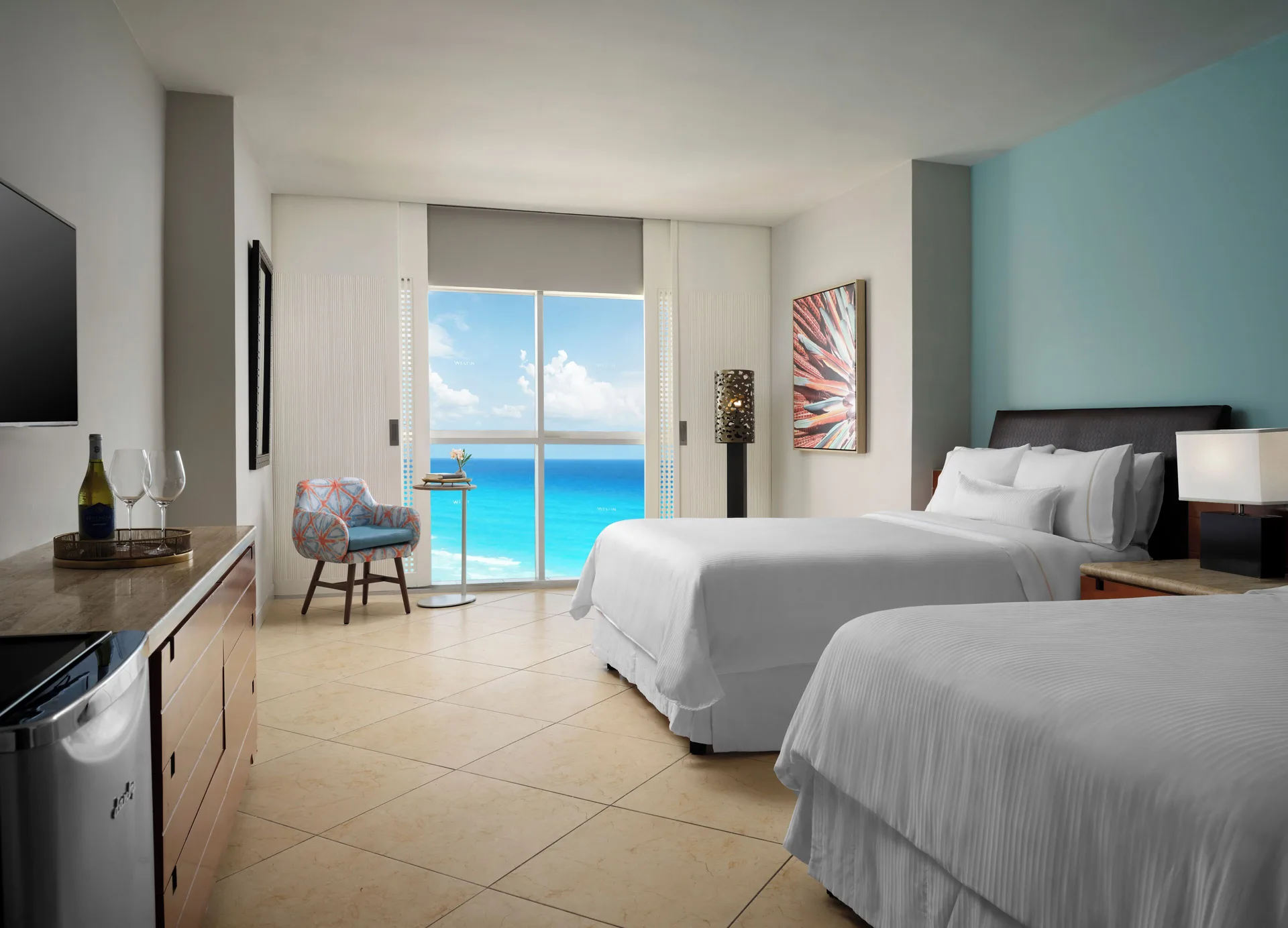 Ocean View room with two beds at The Westin Resort & Spa, Cancun shows a turquoise wall and sea-facing windows.