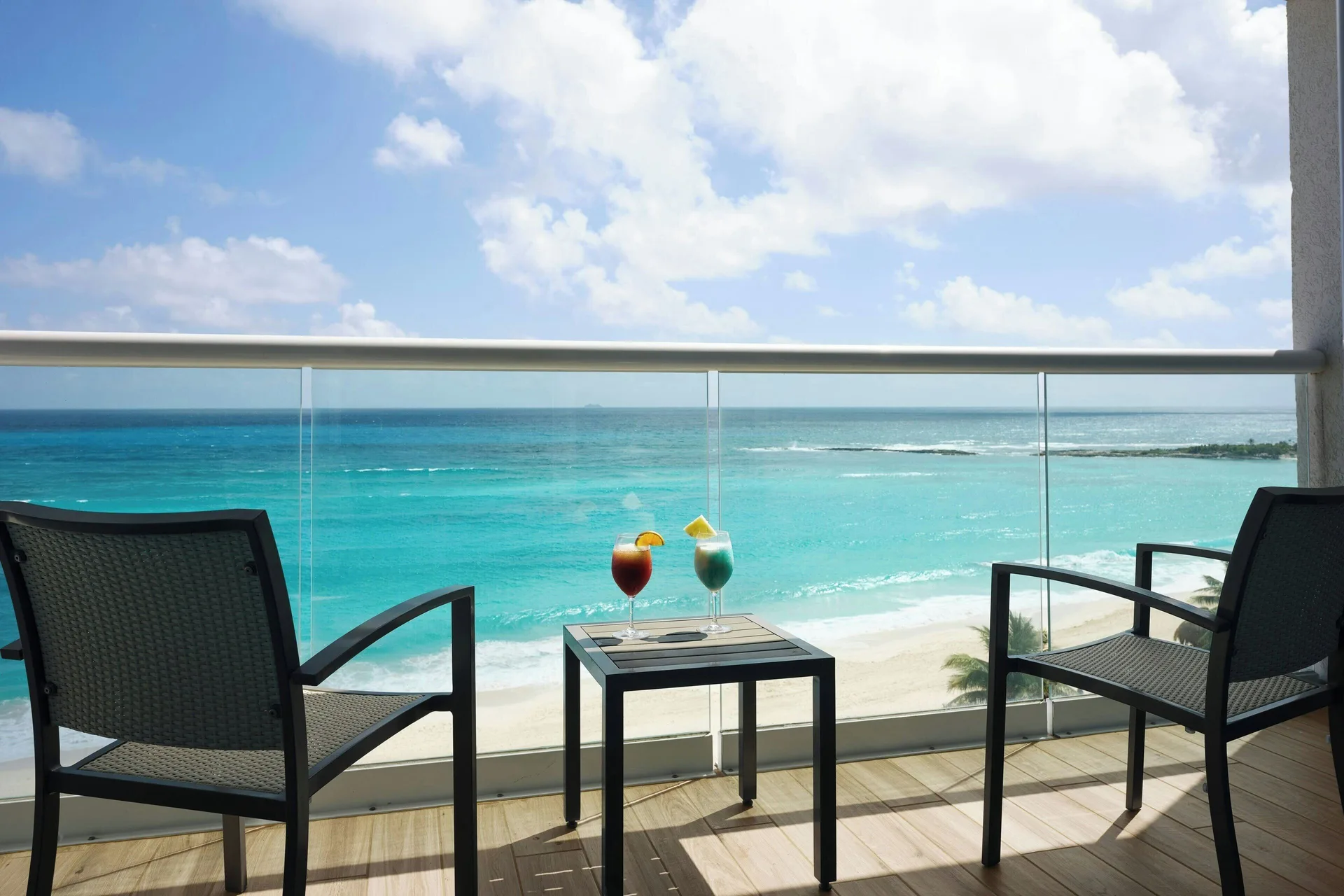 Ocean-view studio balcony with two chairs at The Westin Resort & Spa, Cancun.