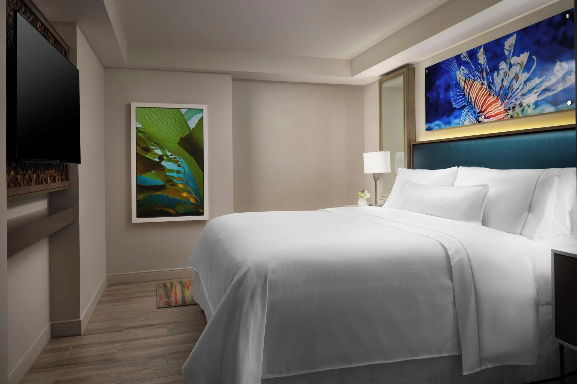 Bedroom with a king bed and wall art in a suite at The Westin Resort & Spa, Cancun.