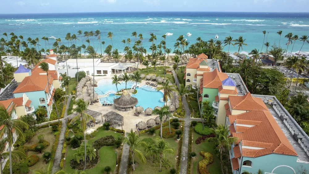 Aerial view of pools, gardens, and oceanfront buildings at TRS Turquesa Hotel.