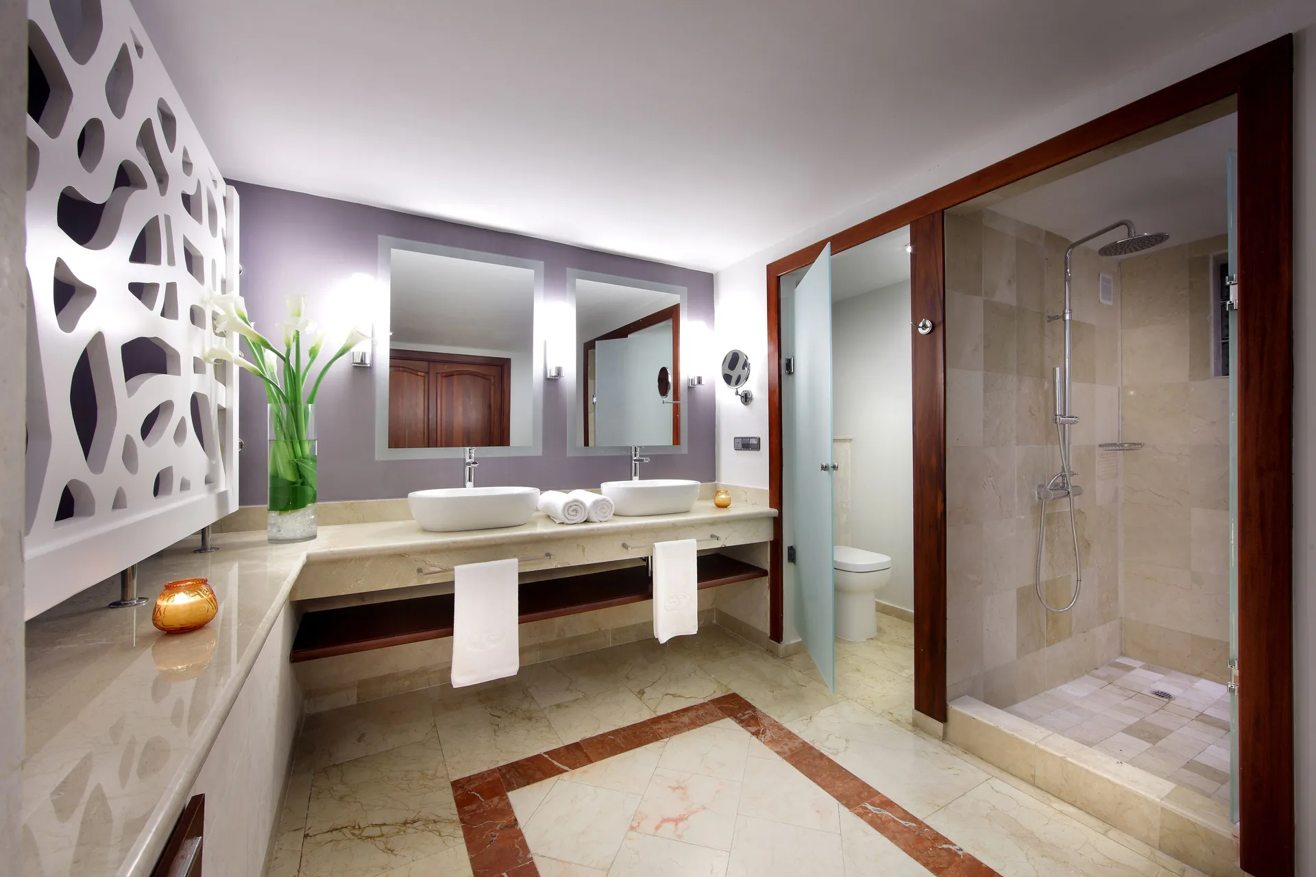 Double-vanity bathroom with glass shower at TRS Turquesa Hotel.
