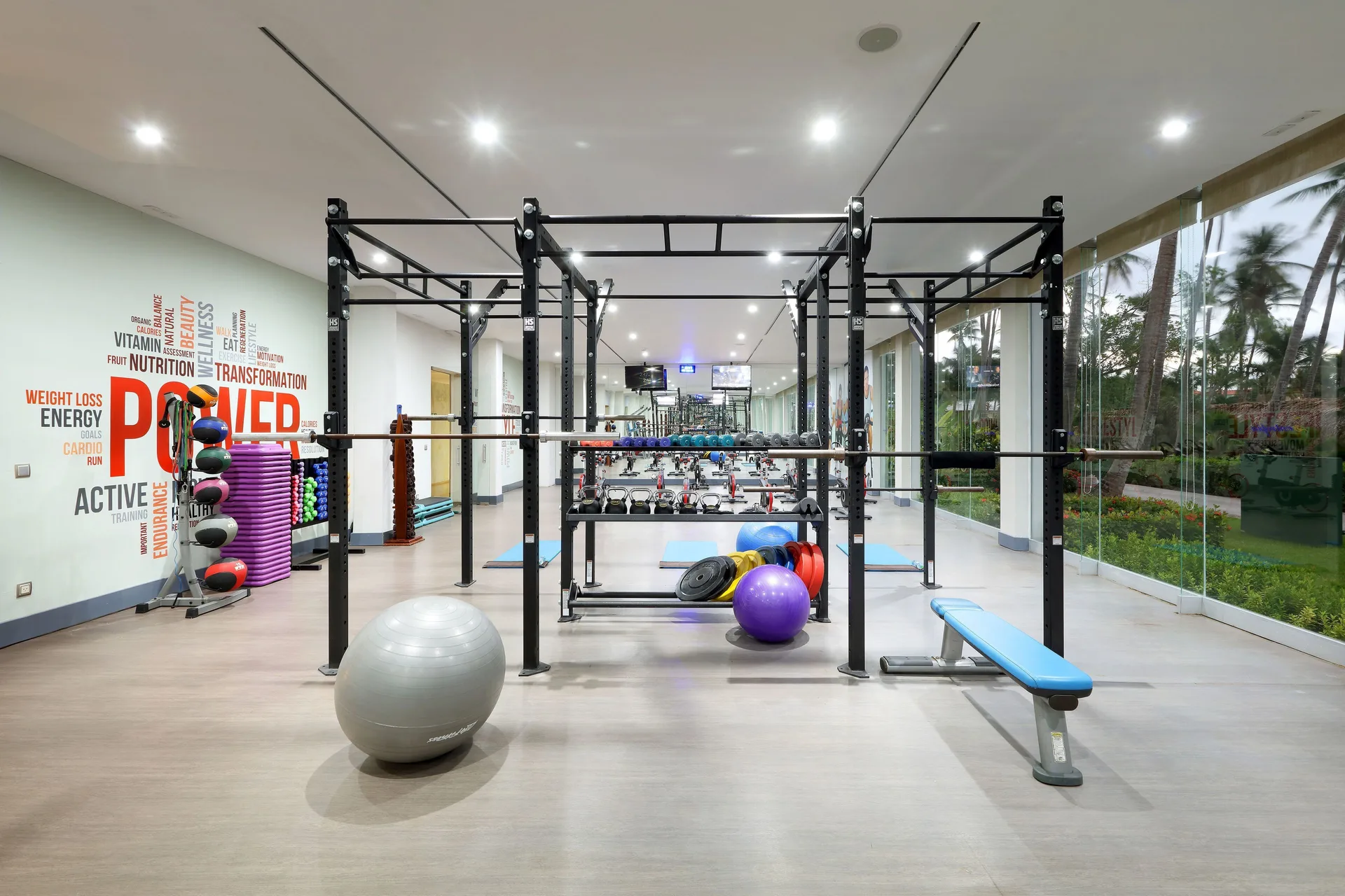 Fitness room with power rack and exercise equipment at TRS Turquesa Hotel.