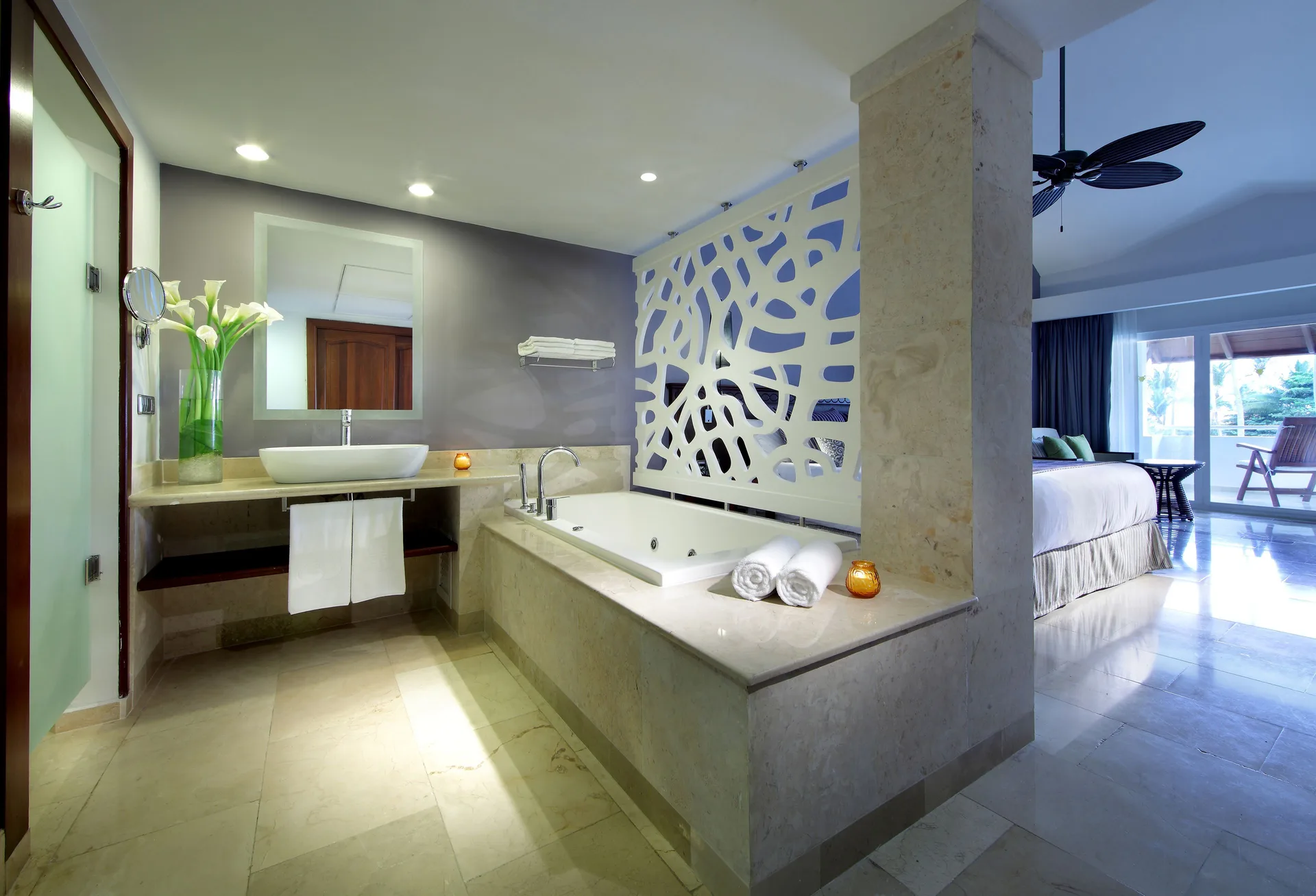 Guest room bathroom with soaking tub and bedroom beyond at TRS Turquesa Hotel.
