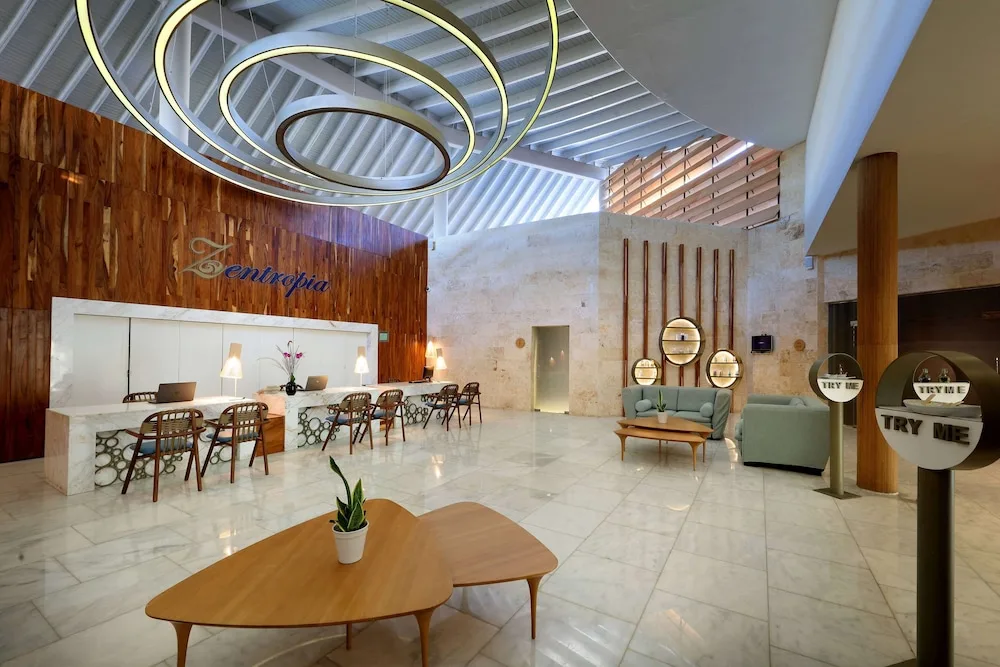 Lobby reception with circular ceiling lights at TRS Turquesa Hotel.