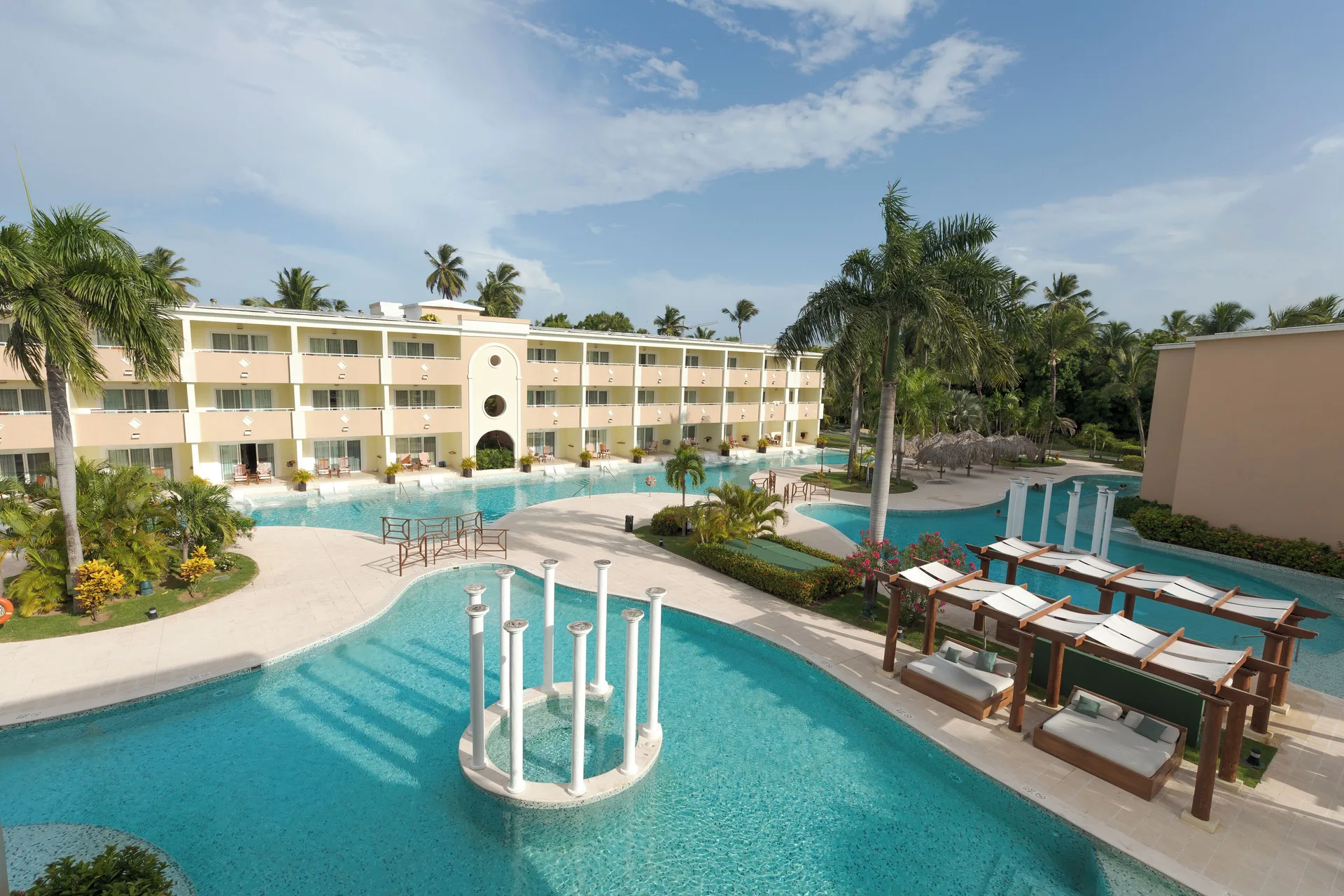 Resort pool courtyard with guestroom building at TRS Turquesa Hotel.