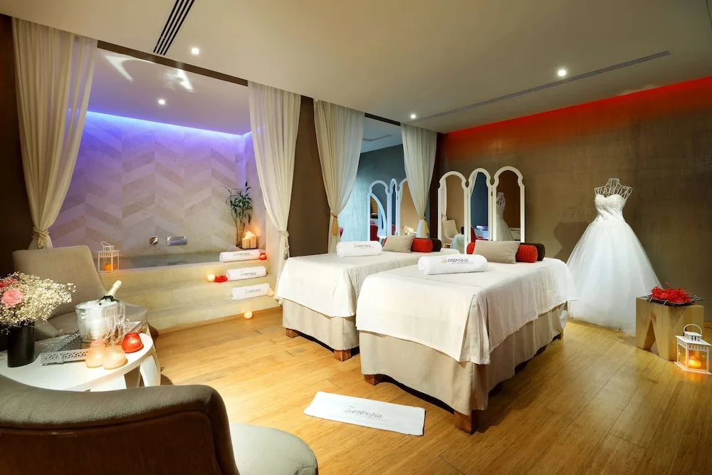 Spa treatment room with two massage beds and bridal decor at TRS Turquesa Hotel.