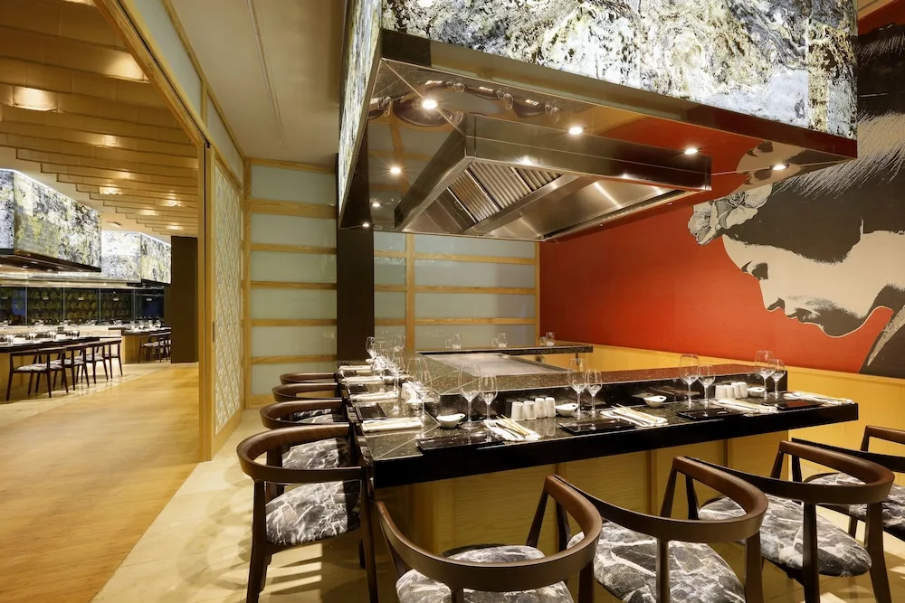 Teppanyaki-style dining counter with place settings inside Kusko at TRS Turquesa Hotel.