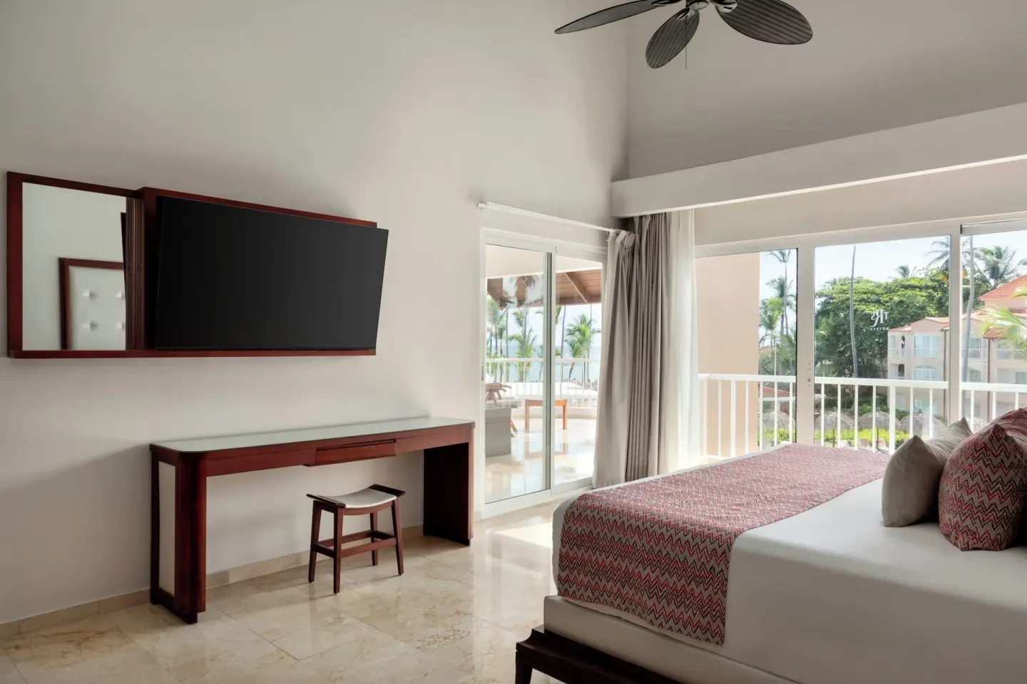 Jacuzzi Terrace Suite Beachside king bed by balcony doors at TRS Turquesa Hotel.