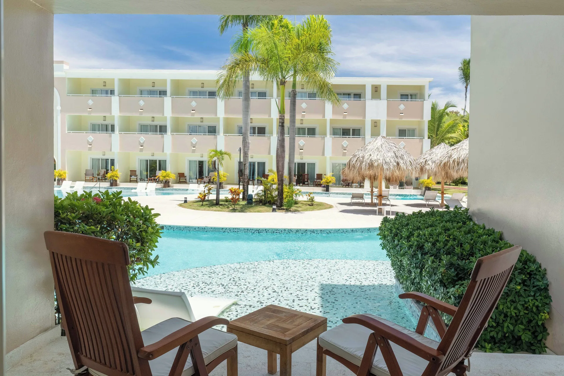 Junior Suite Swim Up terrace chairs overlooking the pool at TRS Turquesa Hotel.