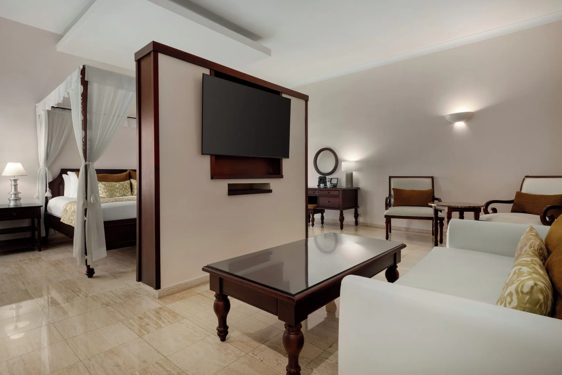 Romance Suite Poolside with canopy bed, lounge seating and TV at TRS Turquesa Hotel.