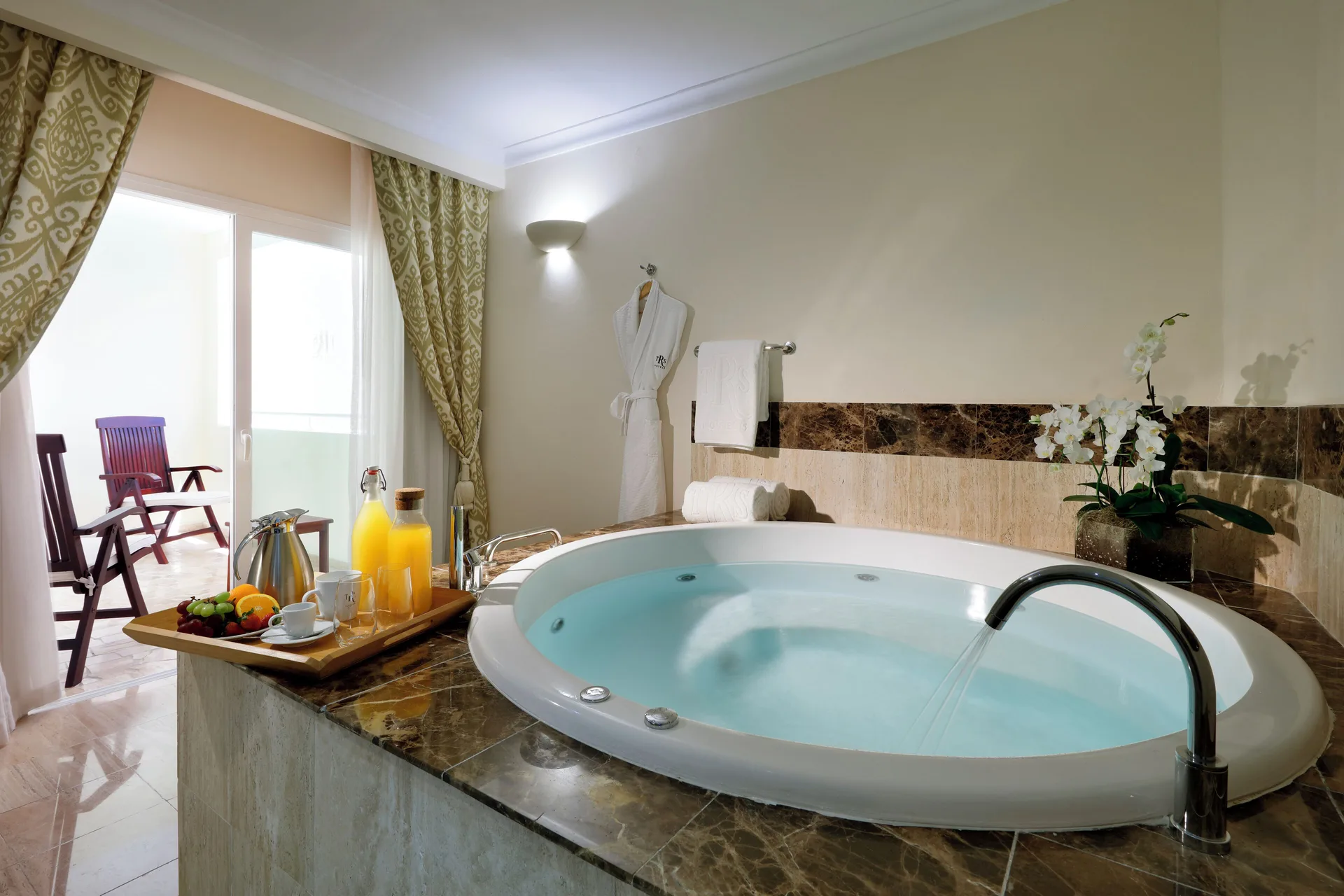 Romance Suite Poolside filled tub with tray and balcony seating at TRS Turquesa Hotel.