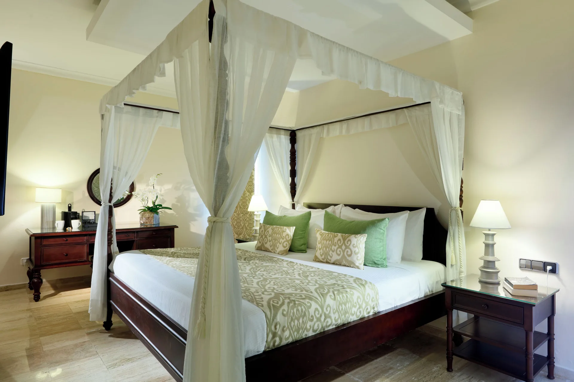 Romance Suite Poolside canopy bed with bedside lamps at TRS Turquesa Hotel.