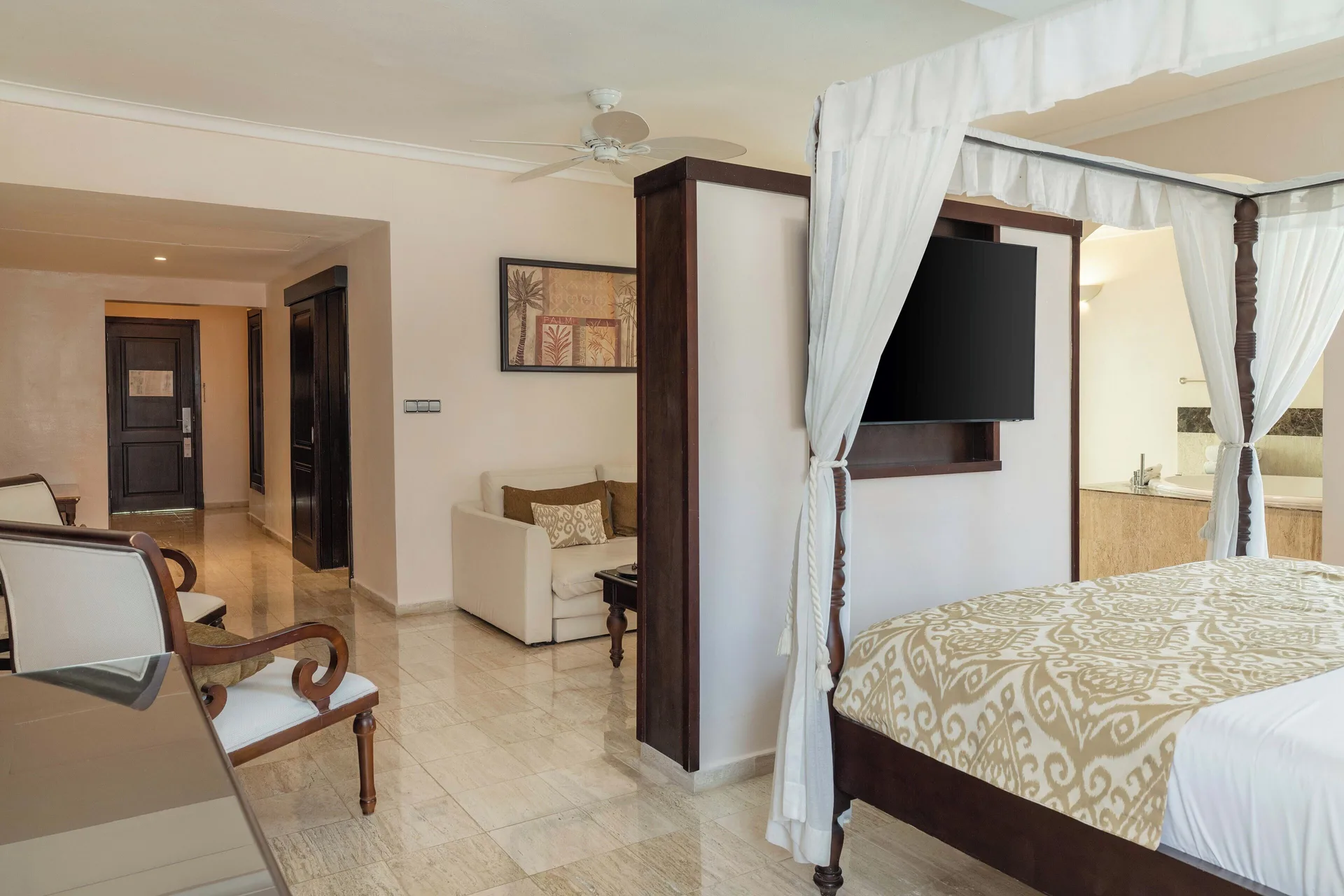 Romance Suite Swim Up bedroom view with canopy bed and sitting area at TRS Turquesa Hotel.