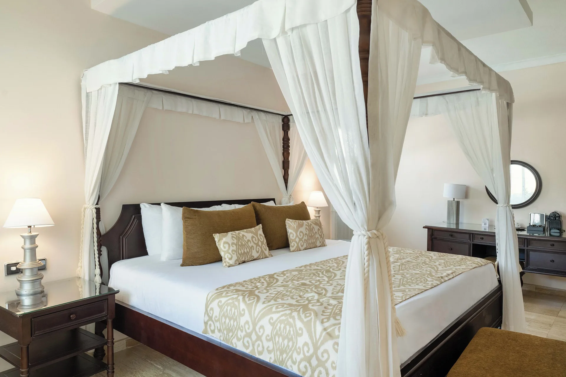 Romance Suite Swim Up canopy bed with white drapes at TRS Turquesa Hotel.