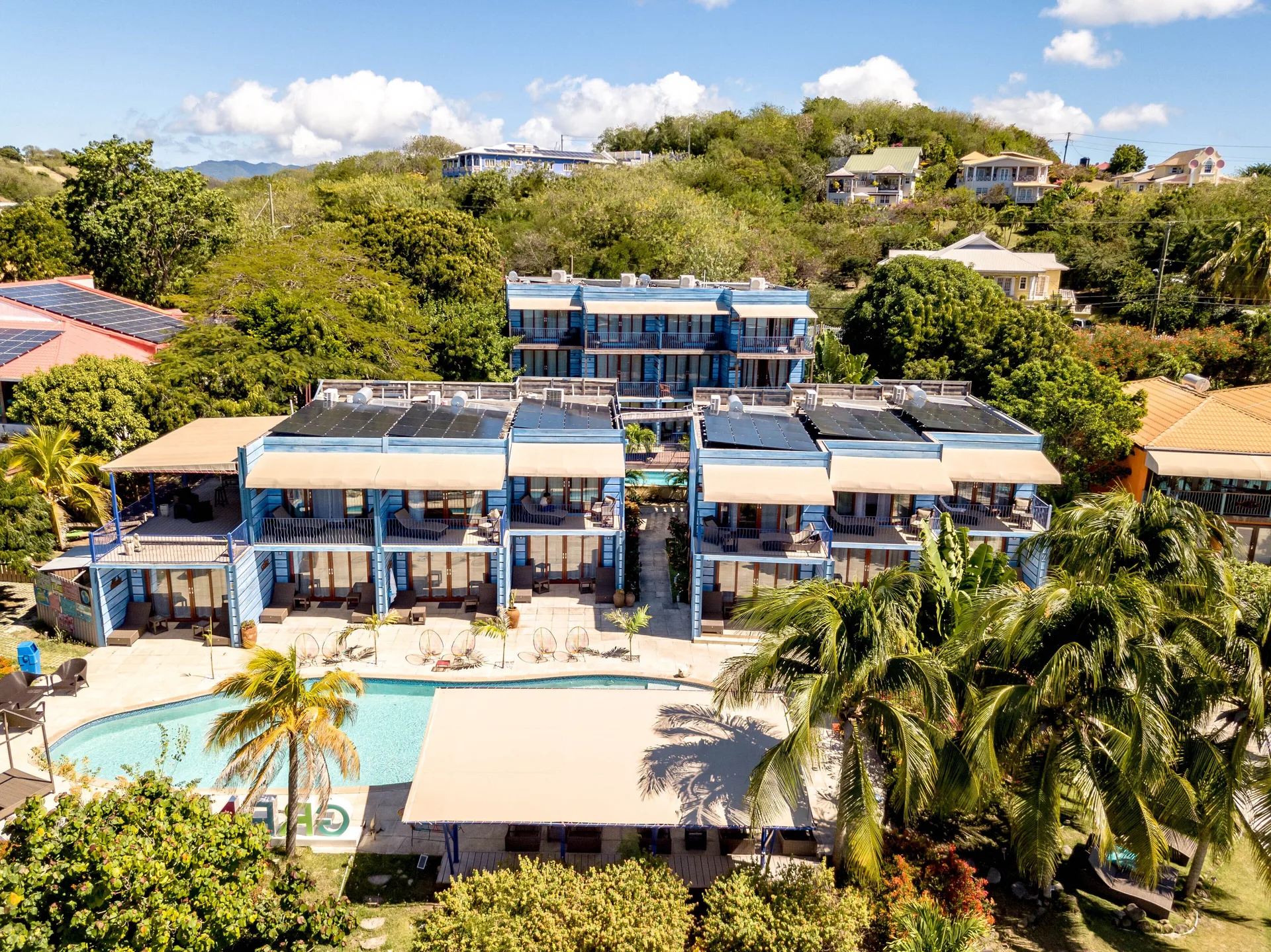 Aerial view of Cocoa Pod Rooms and pool at True Blue Bay Resort.