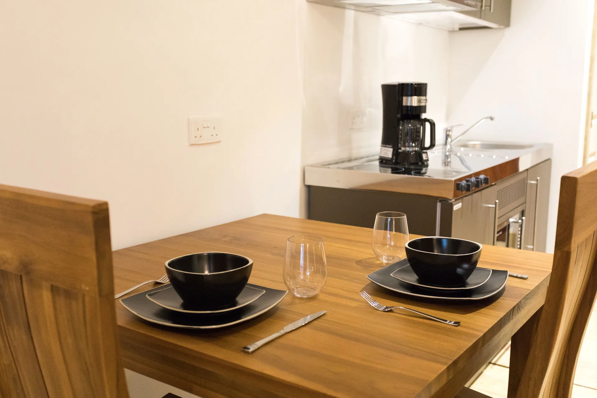 Cocoa Pod Room dining table and kitchenette at True Blue Bay Resort.