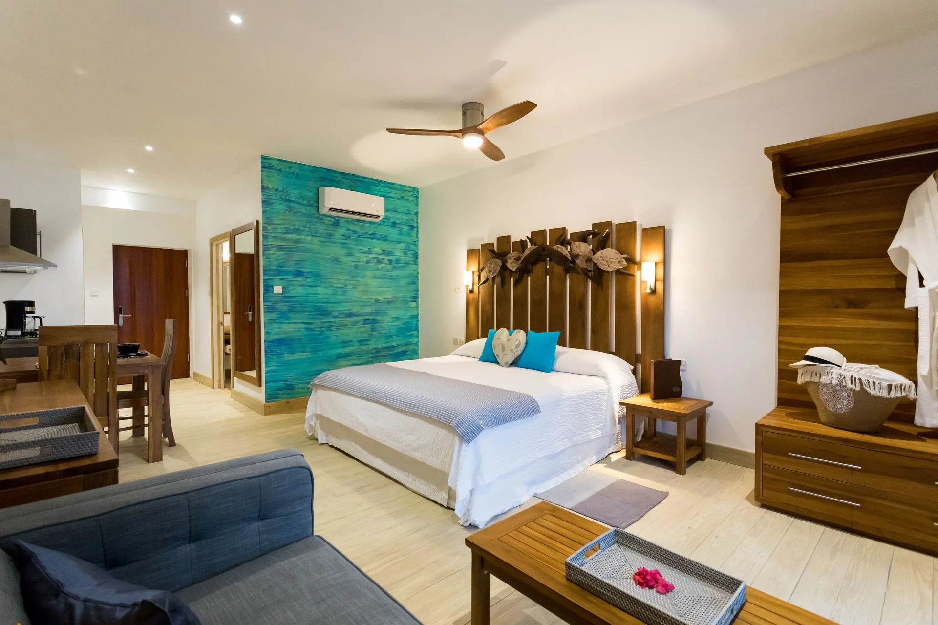 Cocoa Pod Room with king bed, sofa, and kitchenette at True Blue Bay Resort.
