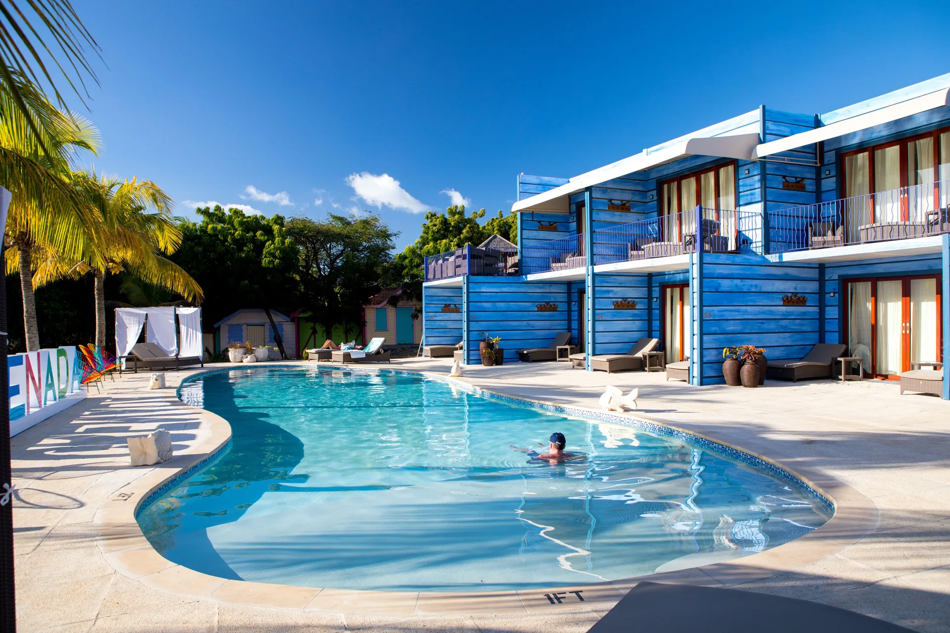 Cocoa Pod Room building beside the pool at True Blue Bay Resort.