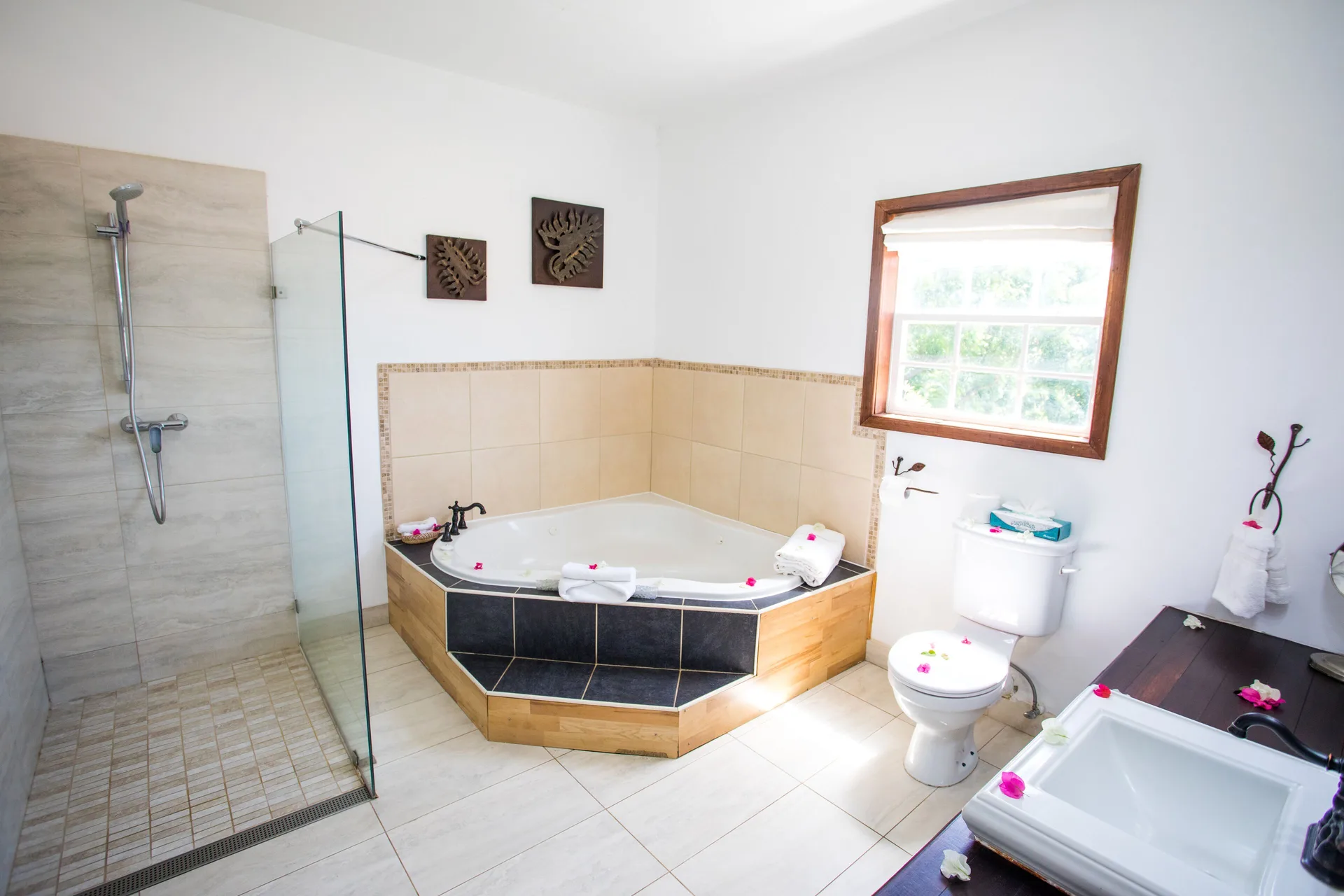 Tower Suite bathroom with corner tub, shower, toilet and vanity at True Blue Bay Resort.