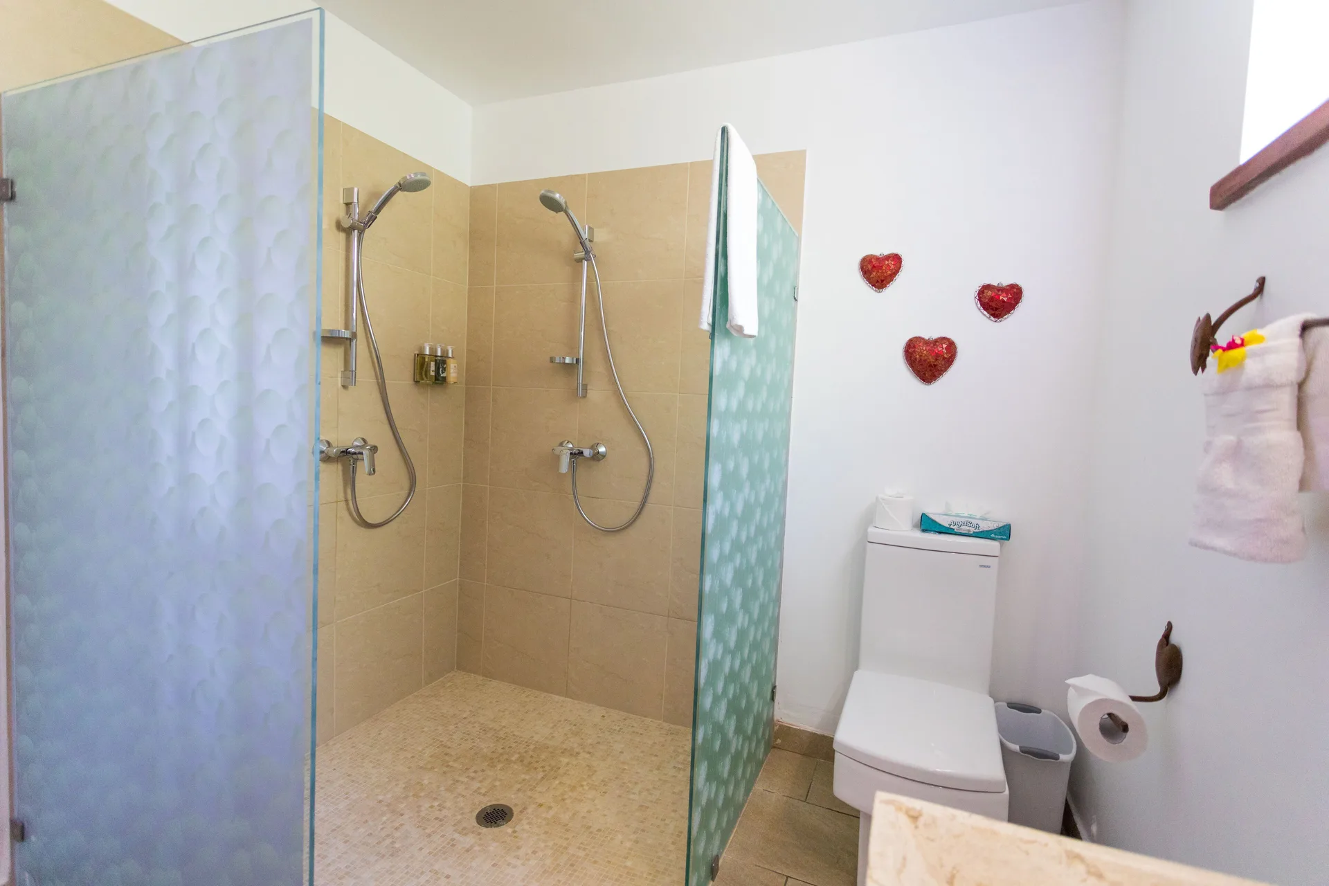 Tower Suite bathroom with double shower and toilet at True Blue Bay Resort.