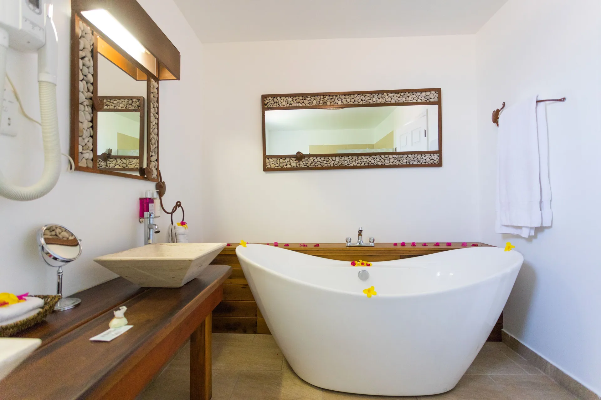 Tower Suite bathroom with freestanding tub and vessel sink at True Blue Bay Resort.