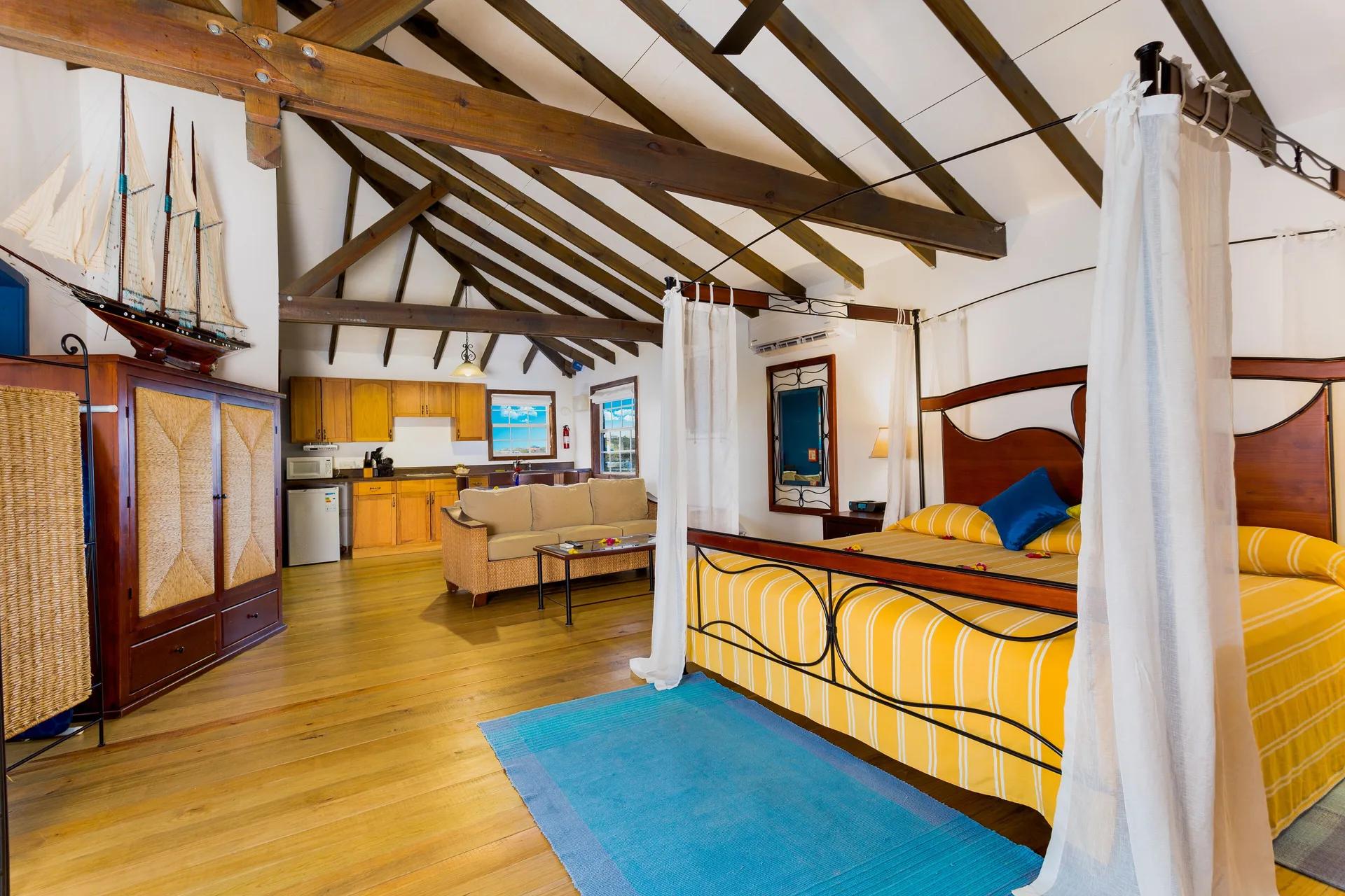 Tower Suite canopy bed and kitchenette at True Blue Bay Resort.