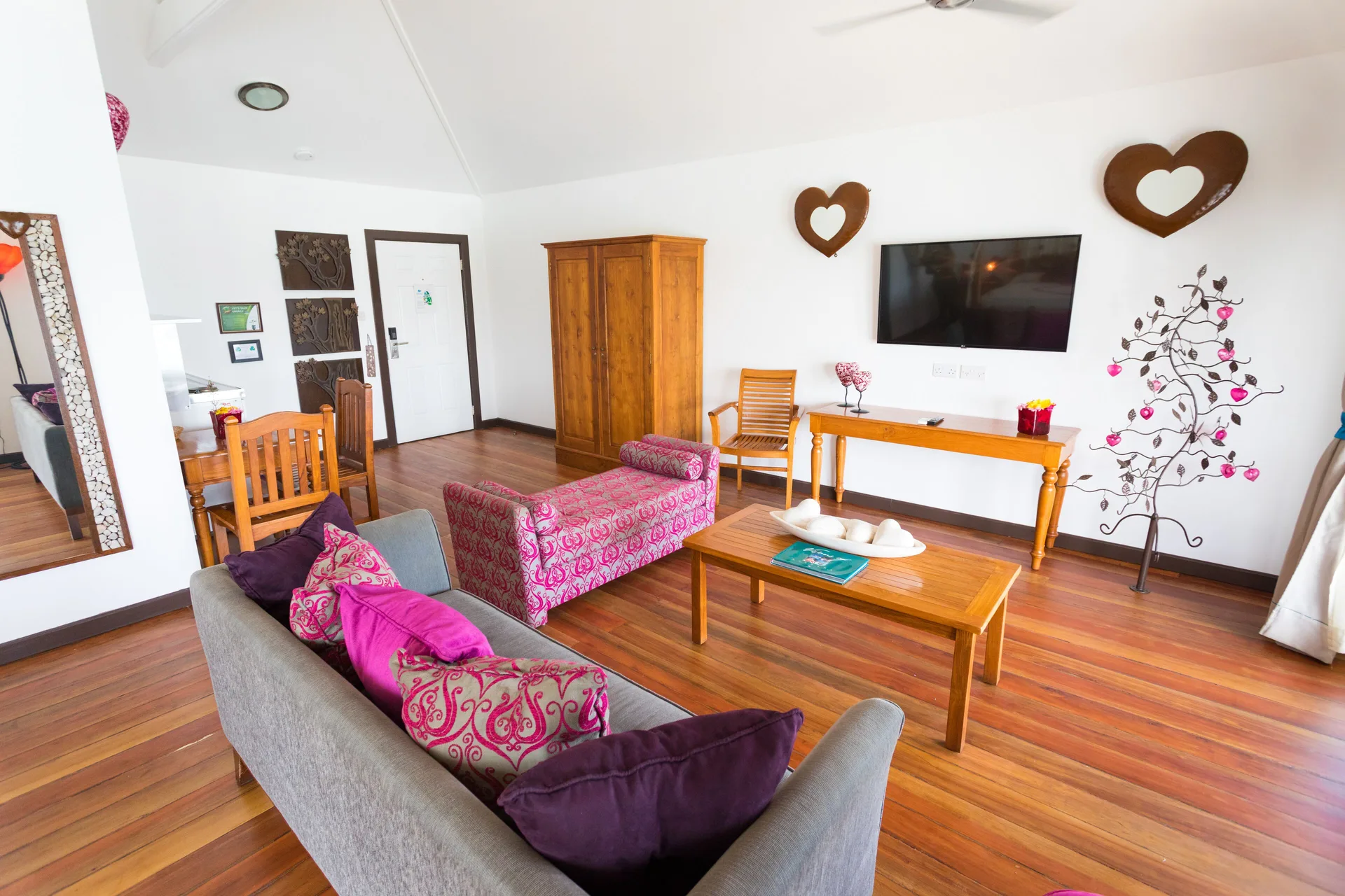 Tower Suite lounge with sofa and wall-mounted TV at True Blue Bay Resort.