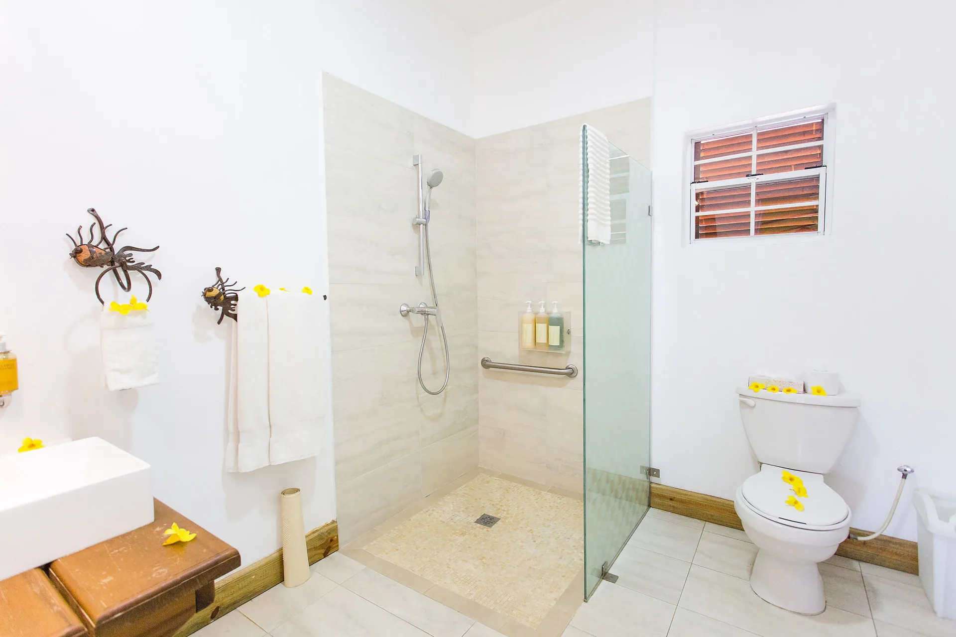 True Blue Bay Resort bathroom at True Blue Bay Resort with walk-in shower, toilet, and vanity.
