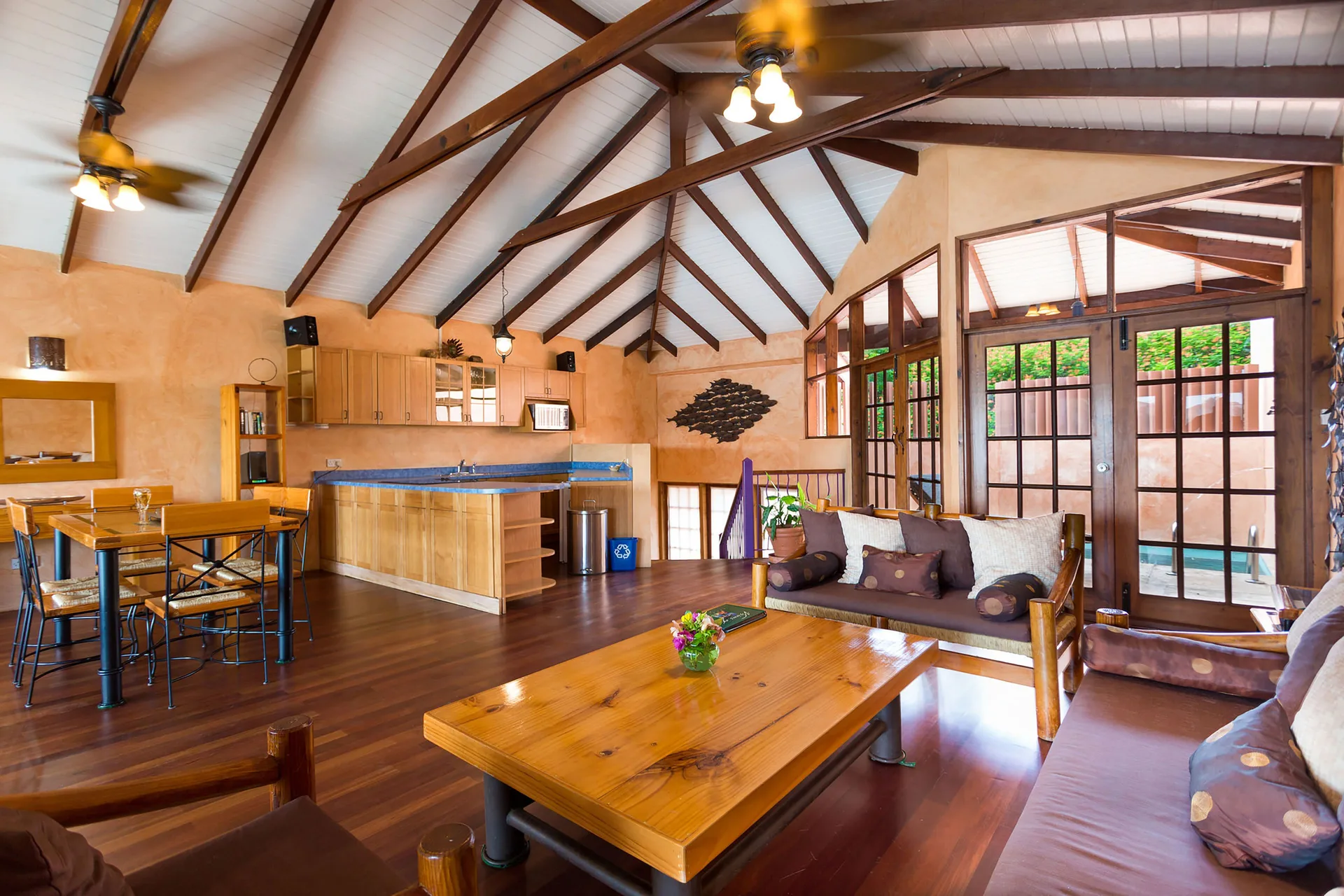 True Blue Bay Resort living room with kitchen, dining table and sofas at True Blue Bay Resort.