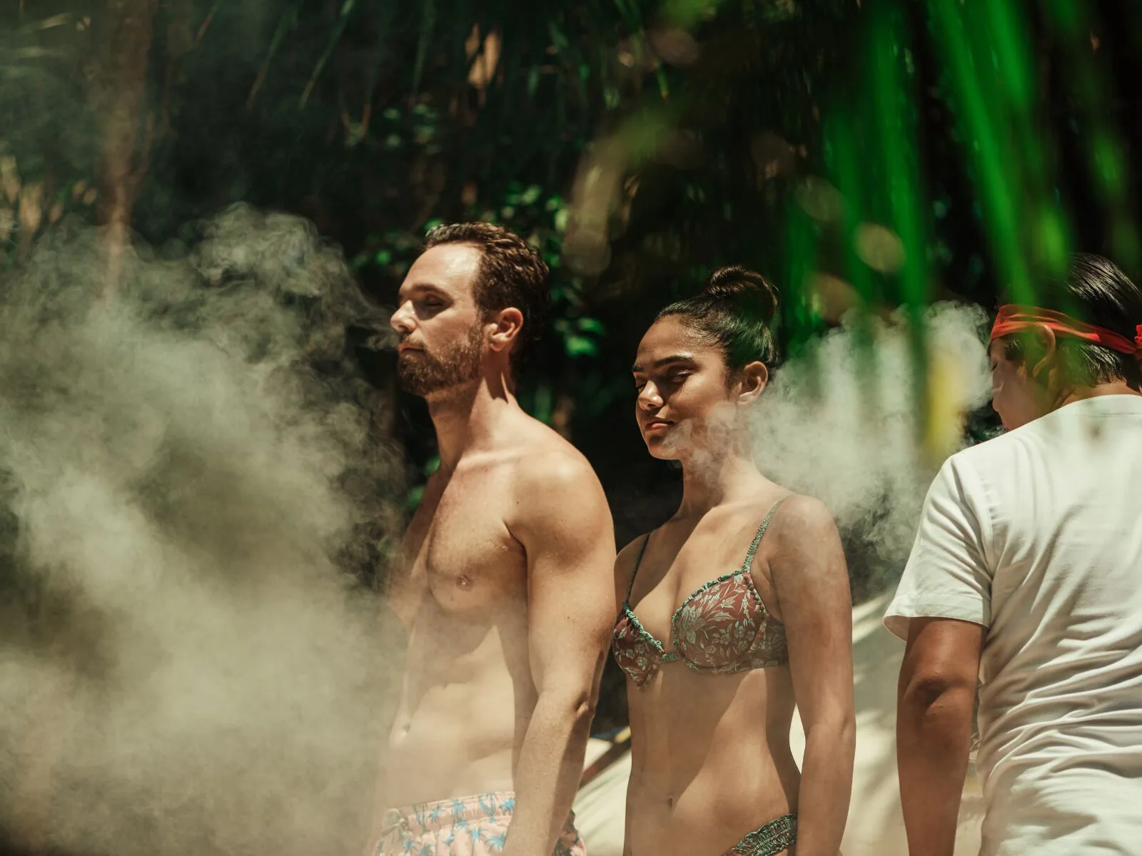 Guests surrounded by steam during an outdoor wellness ritual at Viceroy Riviera Maya.
