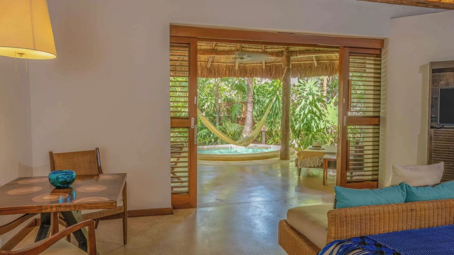 Villa living area opening to a private plunge pool at Viceroy Riviera Maya.