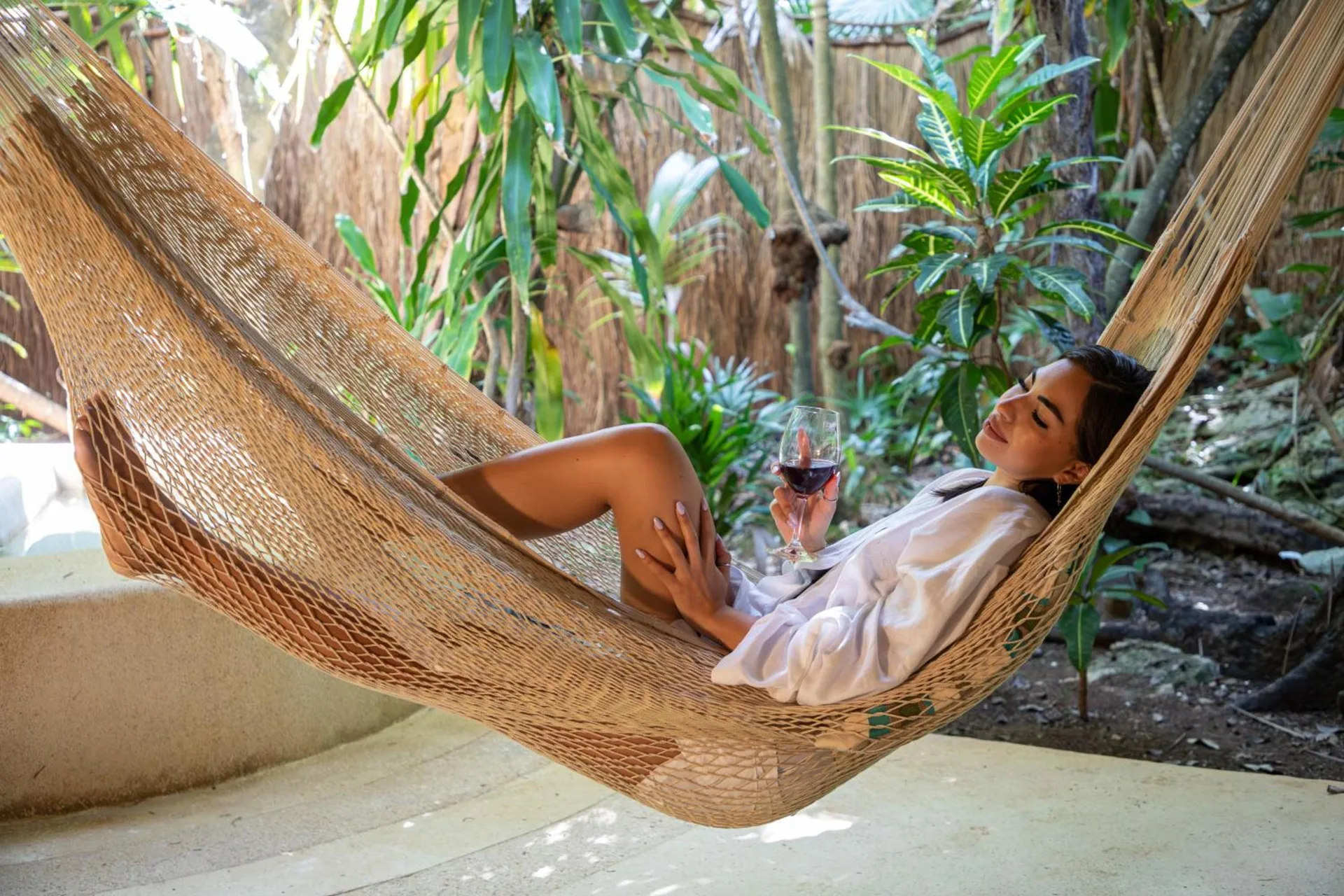 Guest relaxing in a hammock on a luxury villa terrace at Viceroy Riviera Maya.